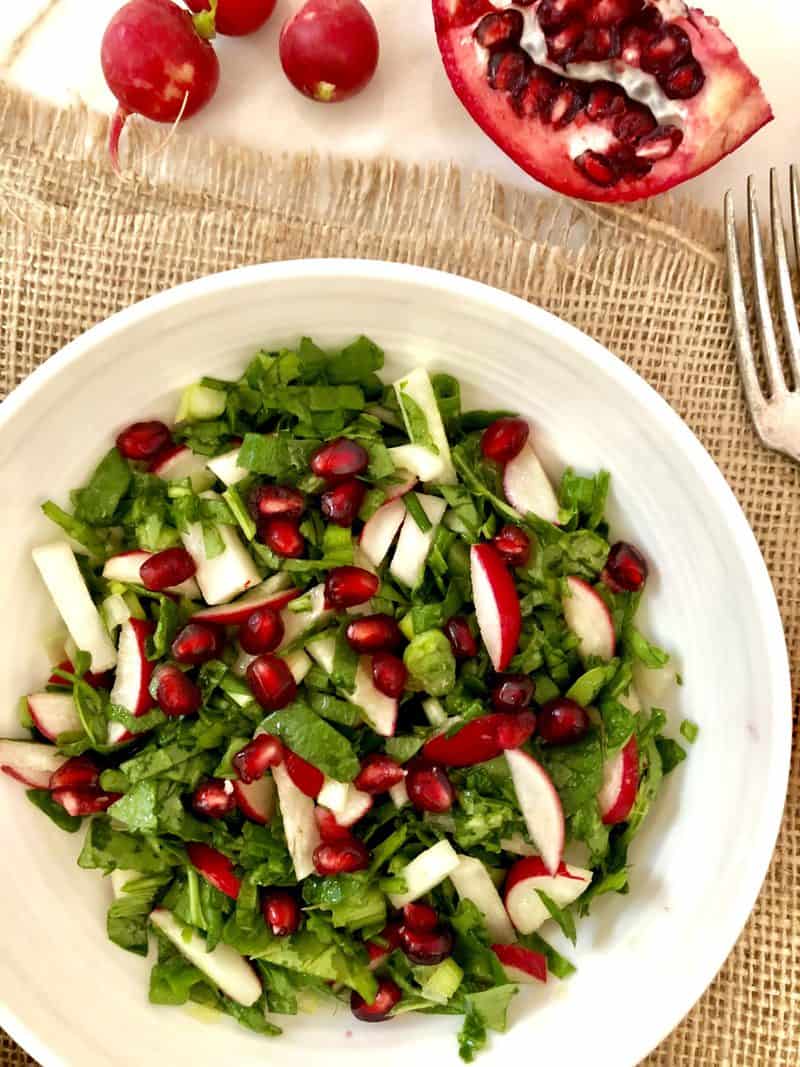 Spinach, raddishes and scallions on a plate