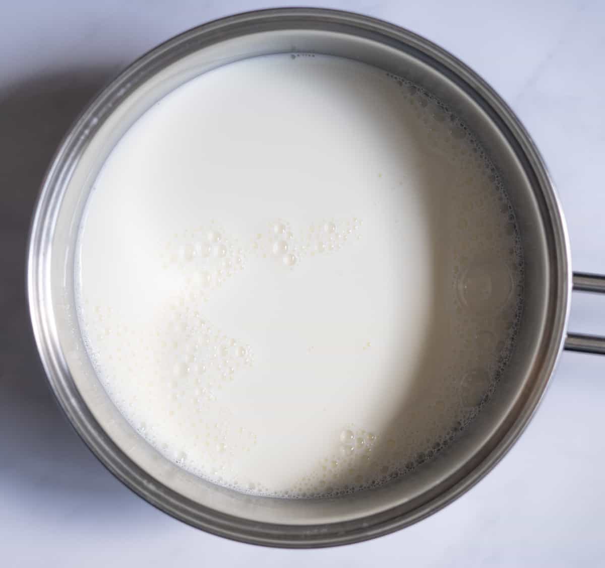 Milk with sugar in a pot