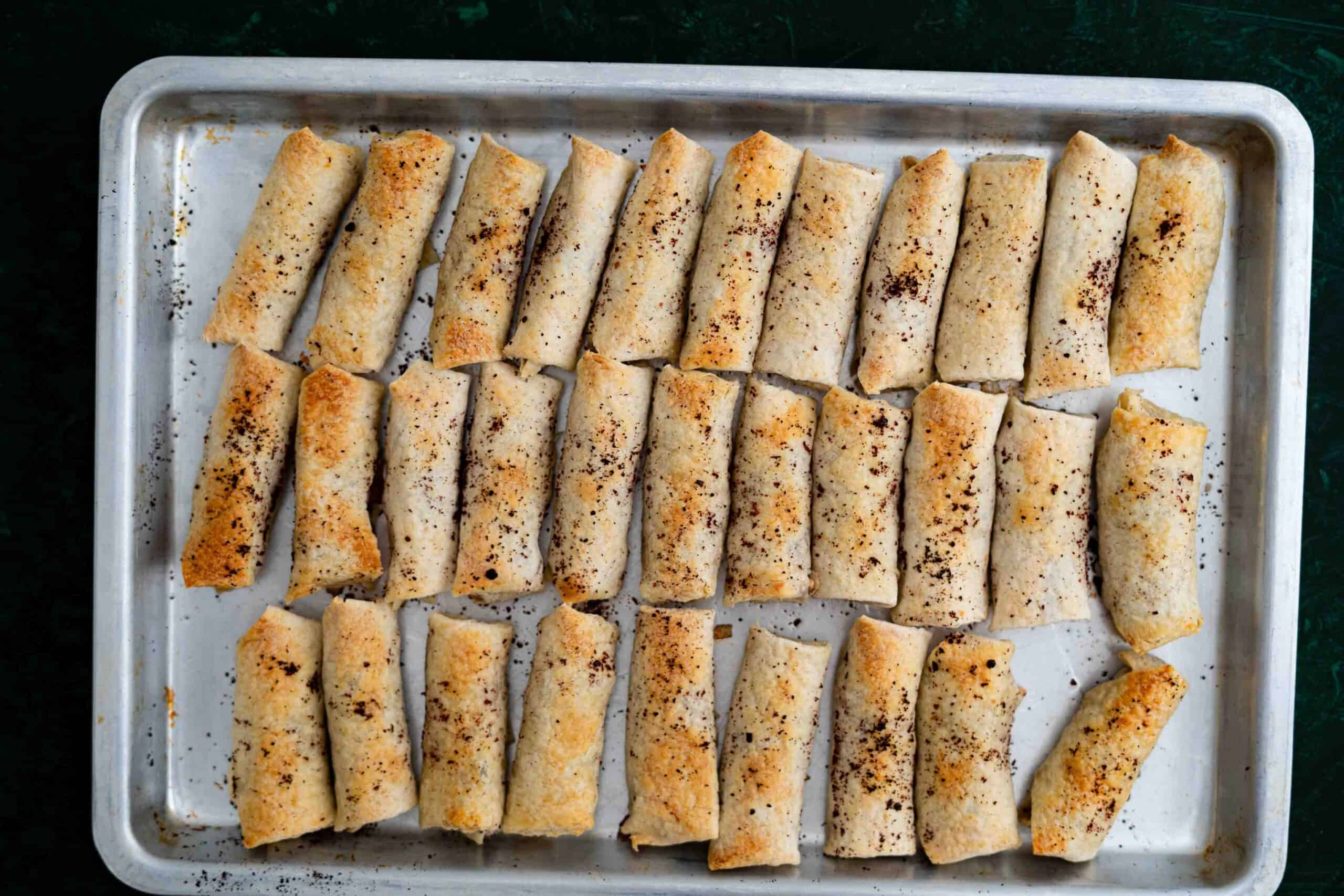 Baked Musakhan rolls on a baking sheet