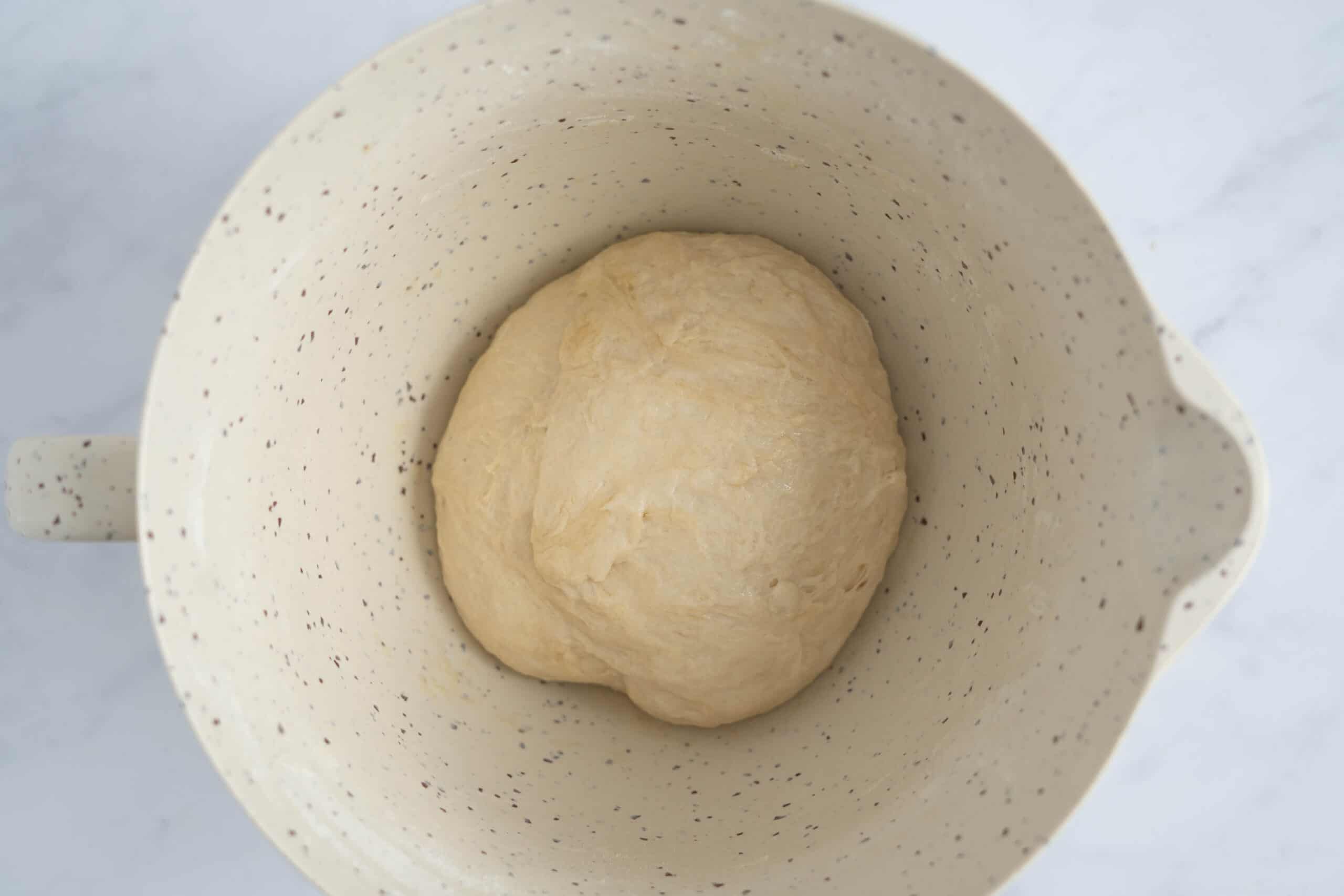 Dough in a bowl mixed before rising