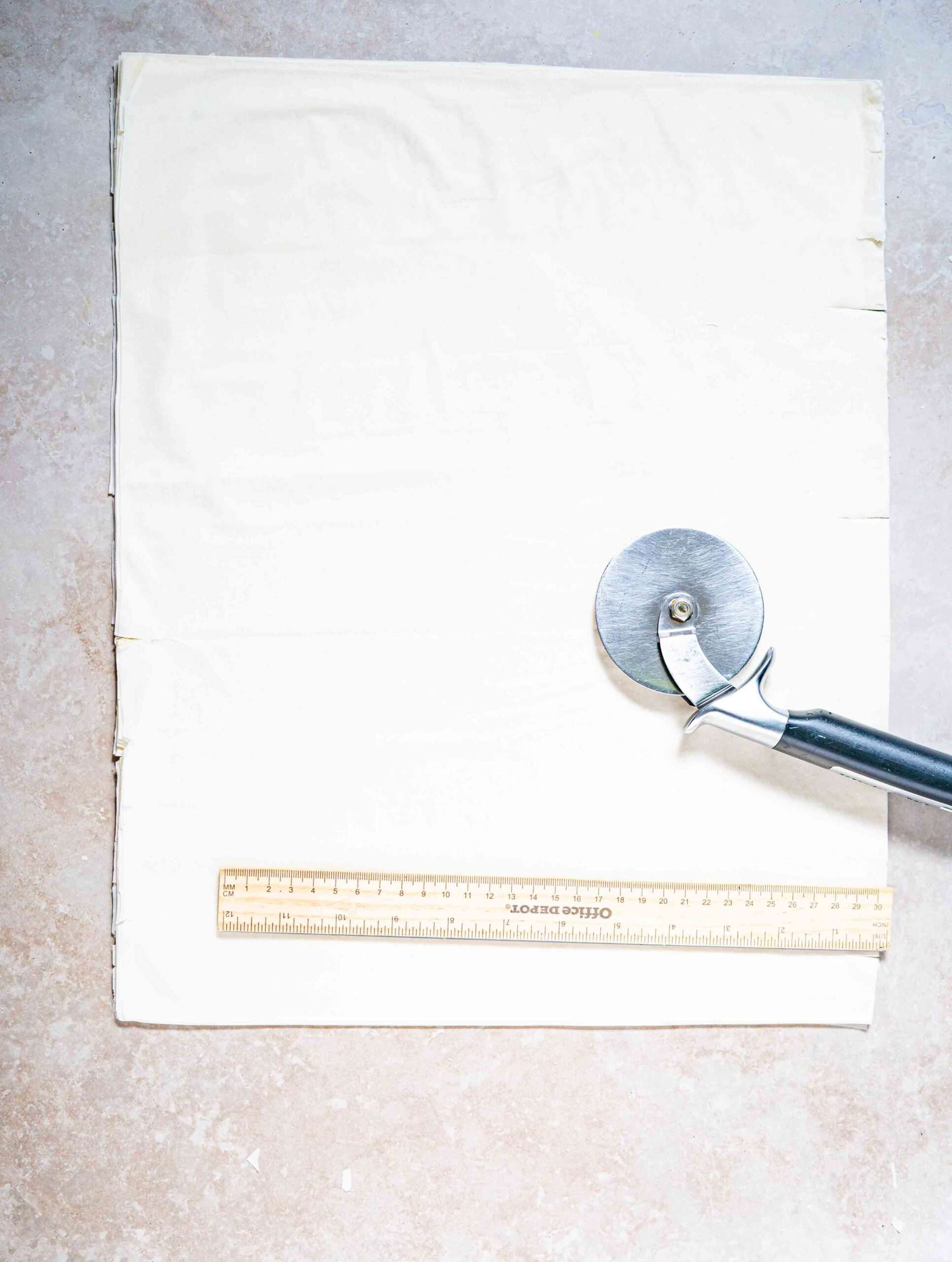 Phyllo dough laid on a flat surface with a ruler