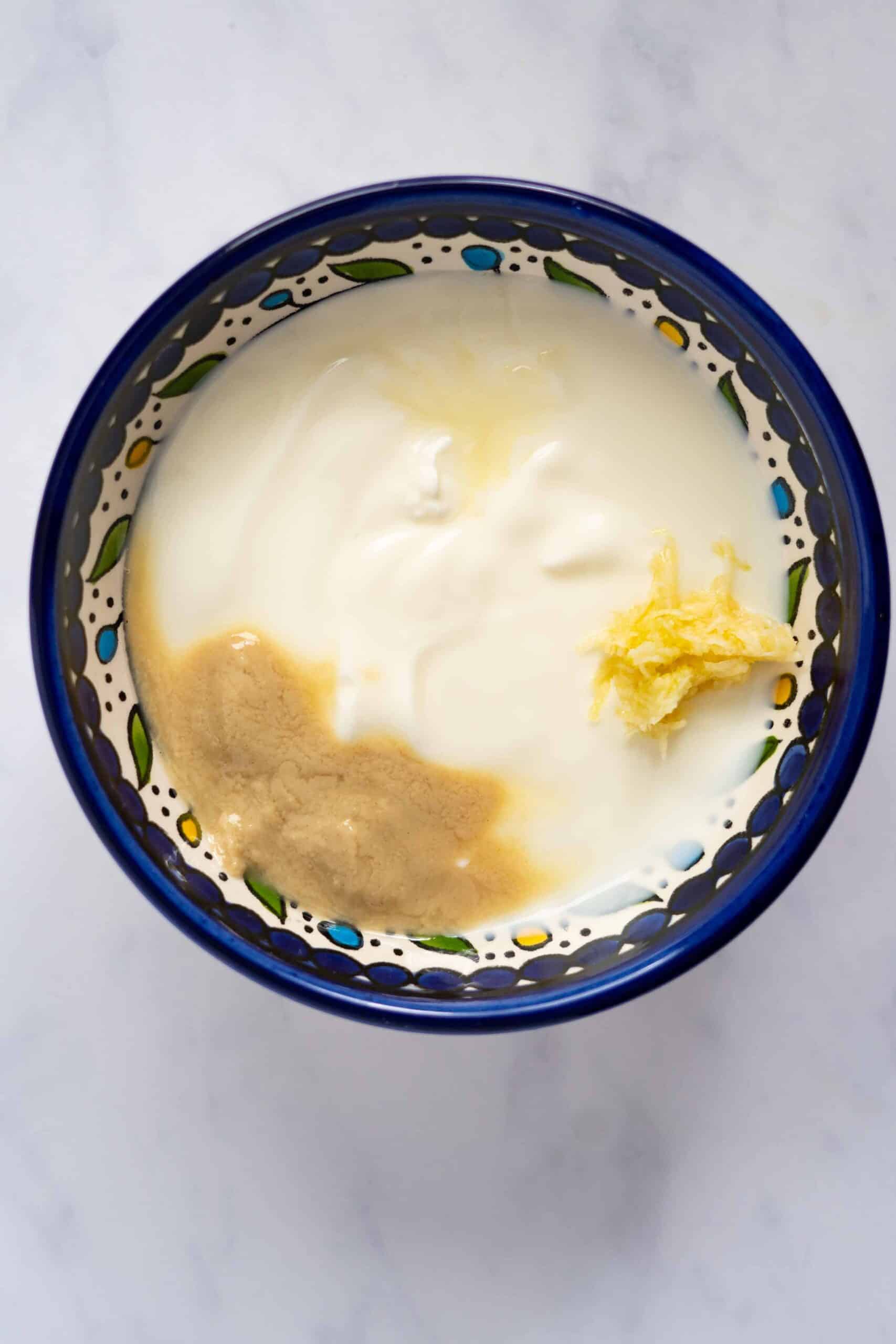 Yogurt with tahini paste, crushed garlic salt and lemon.