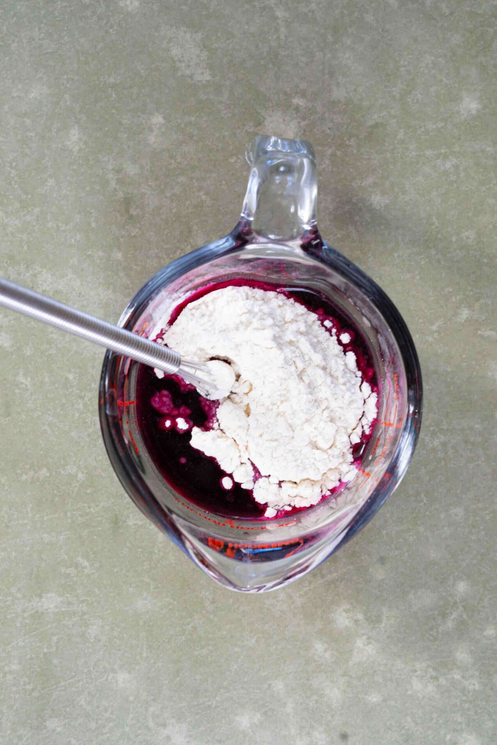Mixing flour with pomegranate juice in a cup