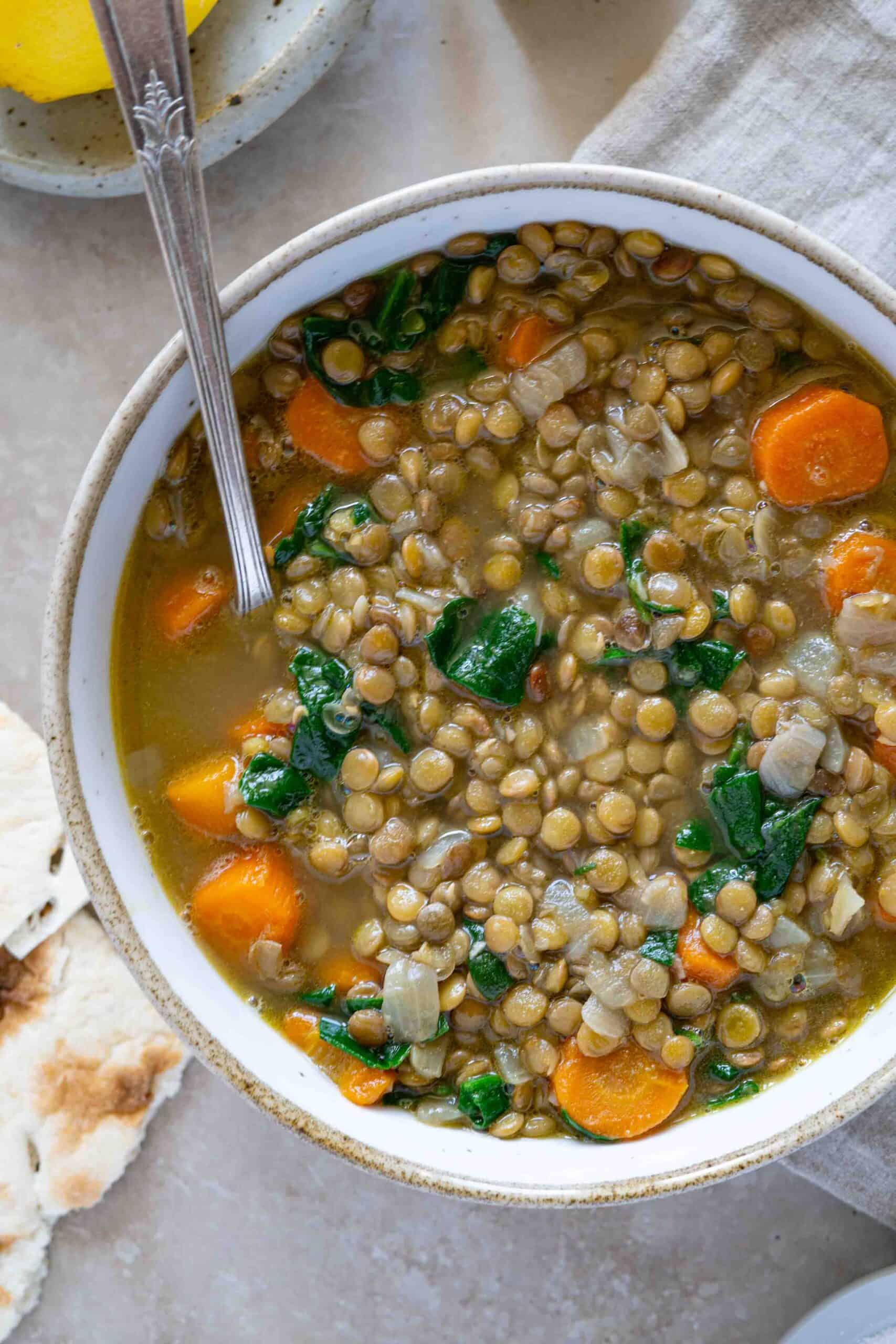 A close up photo for Carrot Lentil Soup in a bowl.
