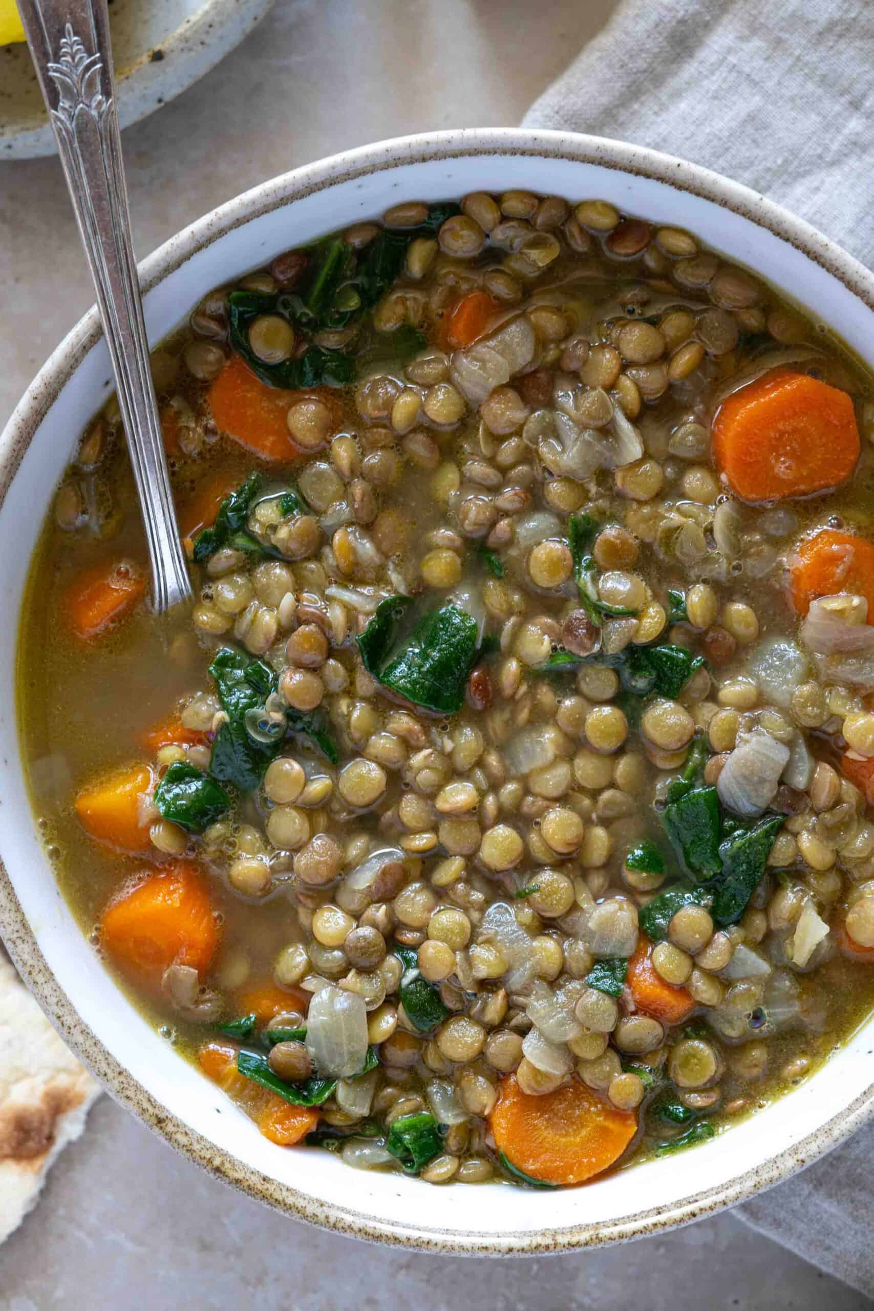 A close up photo for Carrot Lentil Soup in a bowl.