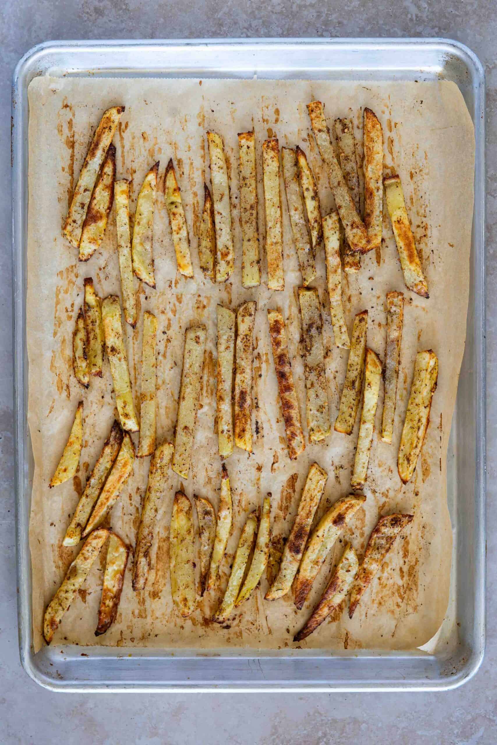 Baked potatoes fries on baking sheet