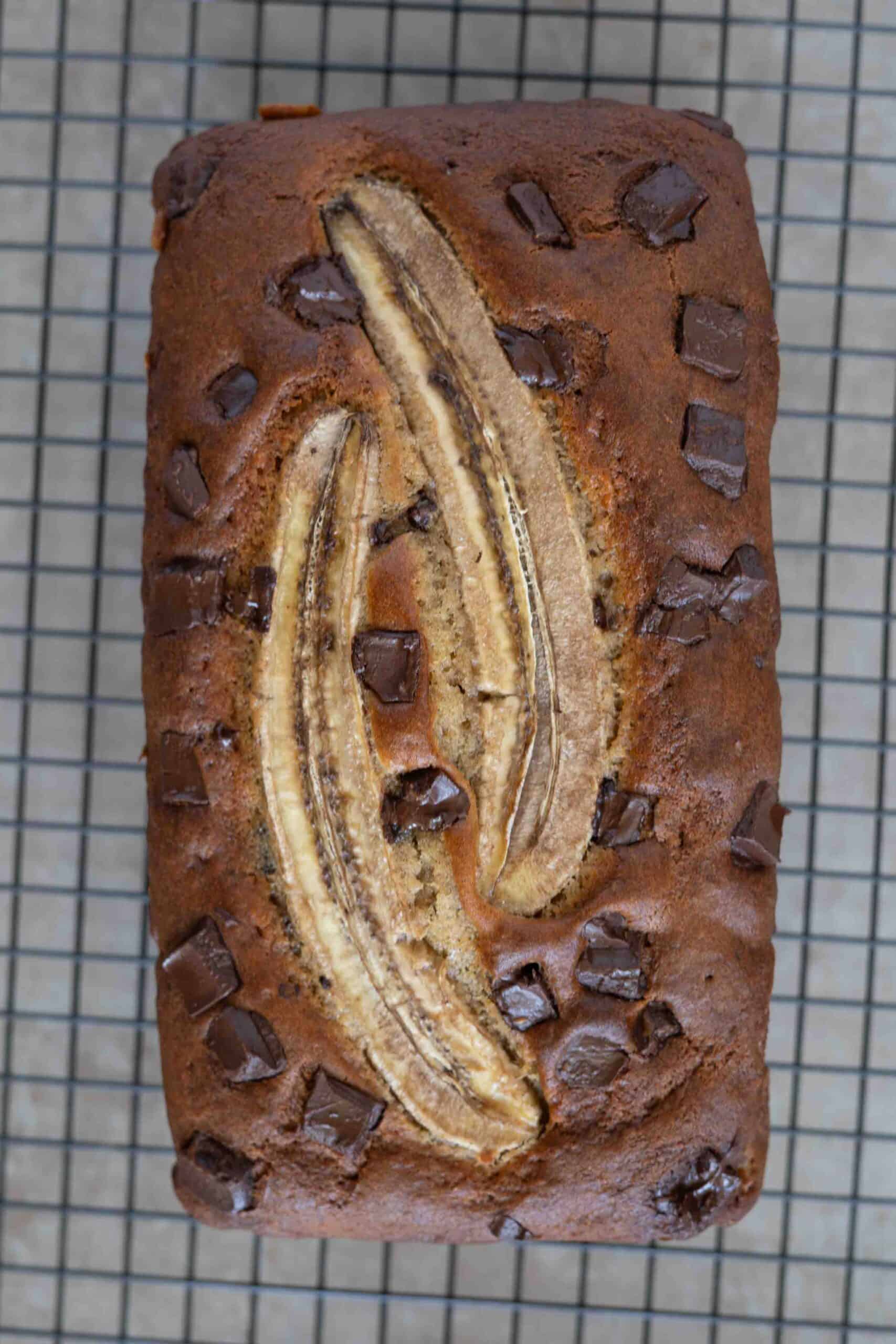 chocolate chunk banana bread on a baking rack