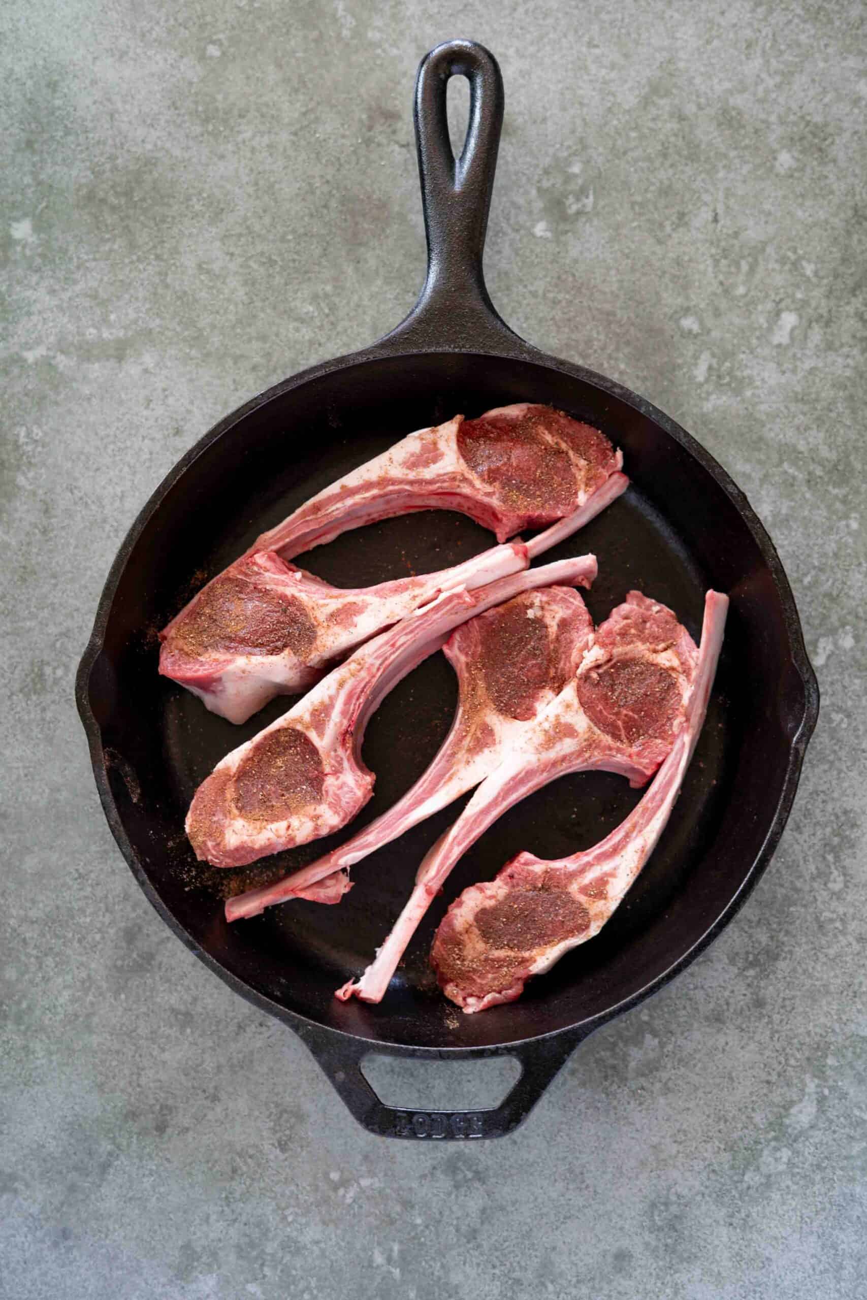 uncooked Lamb chops in cast iron