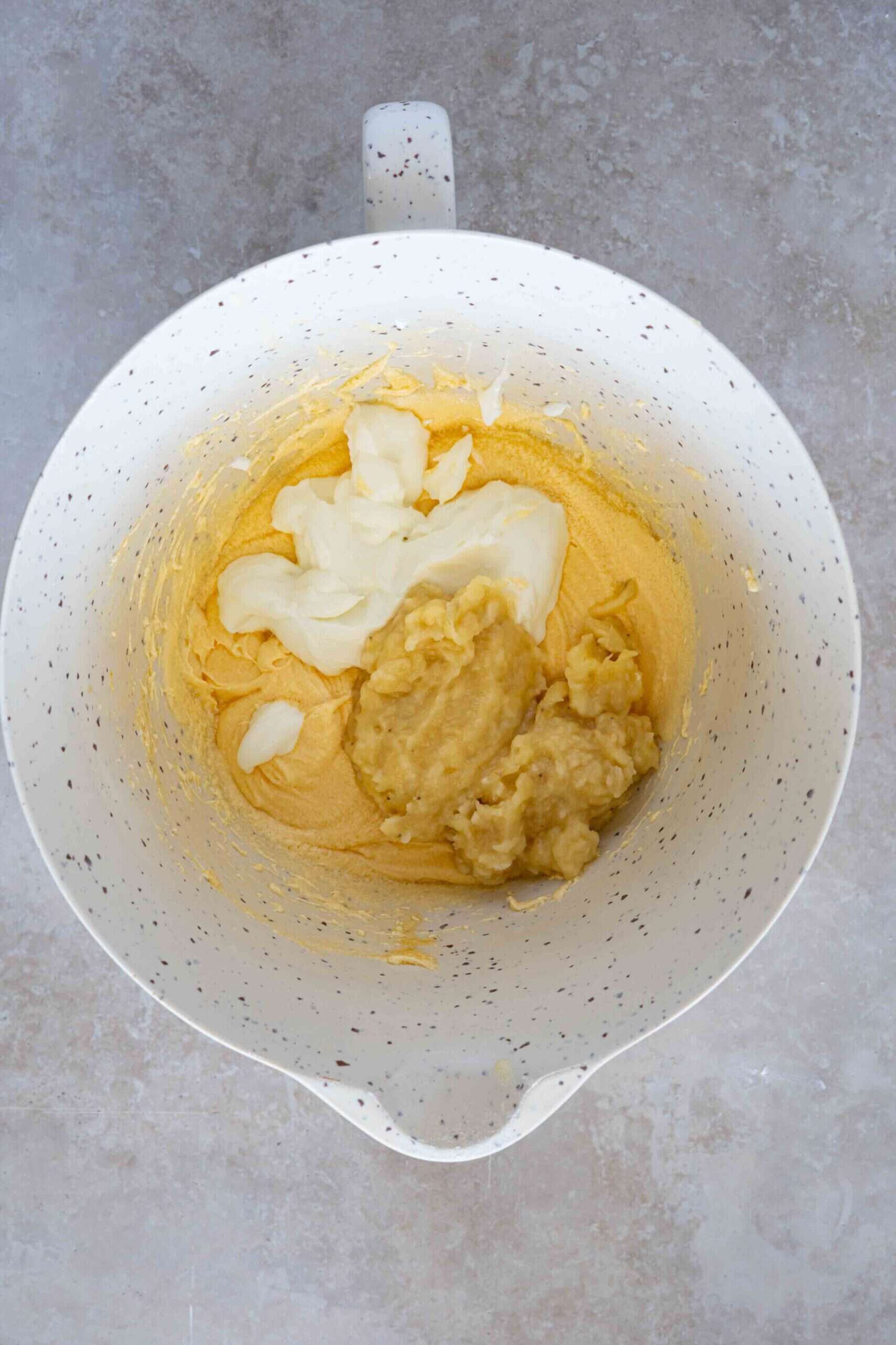 adding smashed banana and yogurt over butter mixure