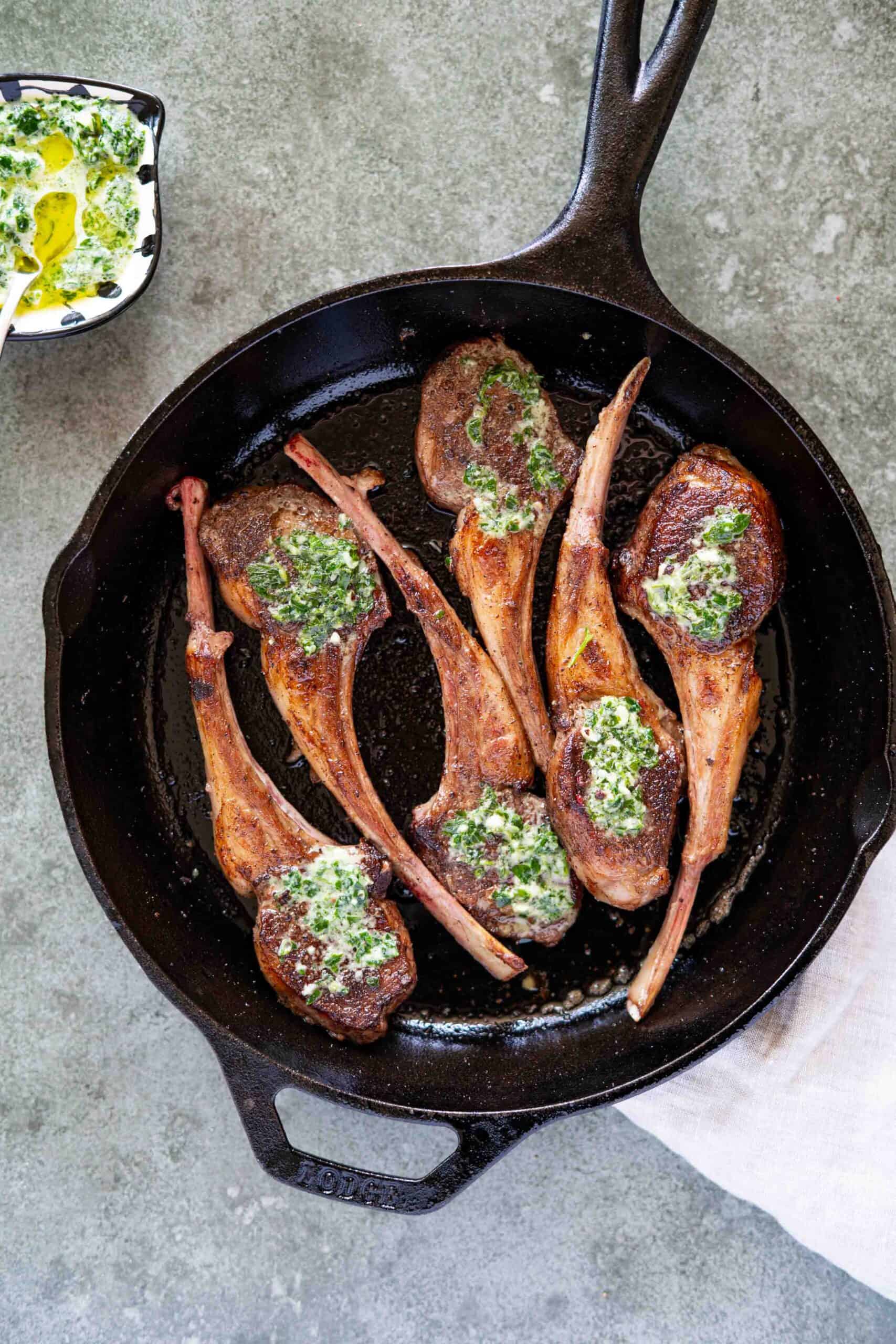 lamb chops done on cast iron covered with garlic parsley paste