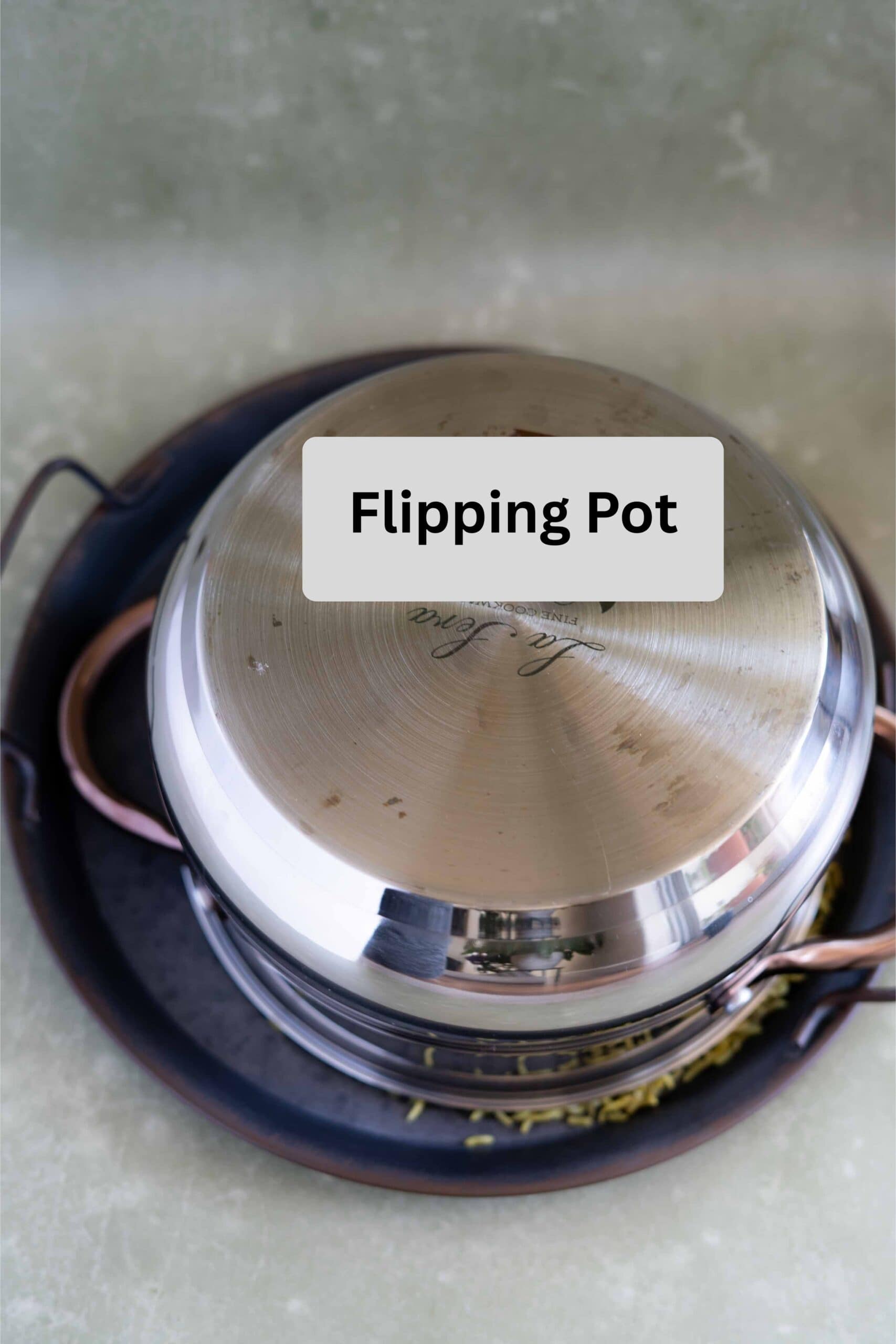 flipping makloube pot after cooking over a serving tray