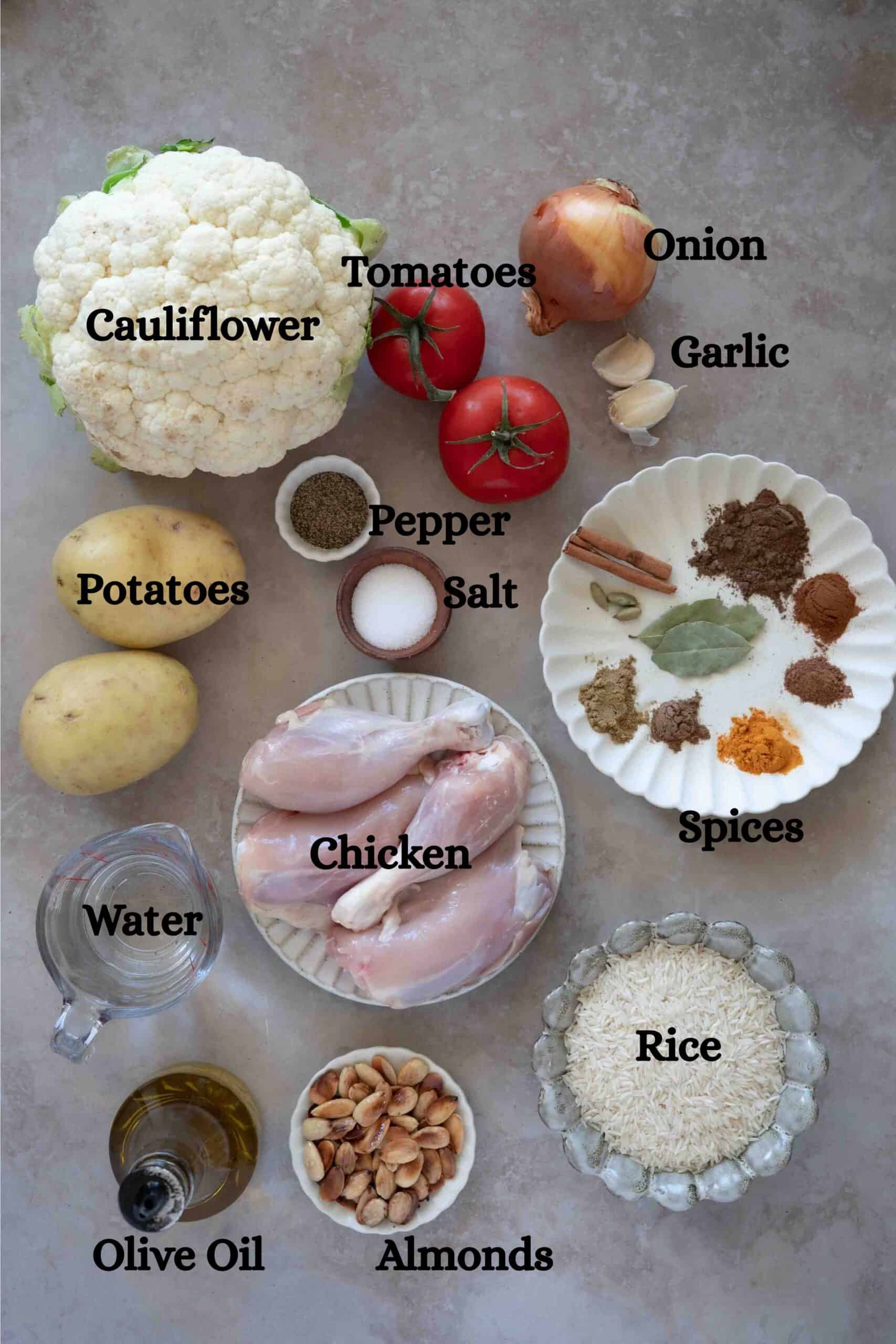Makloubeh Ingredients: Cauliflower, chicken, rice, tomatoes, potatoes, water, spices, olive oil, almonds, salt and pepper