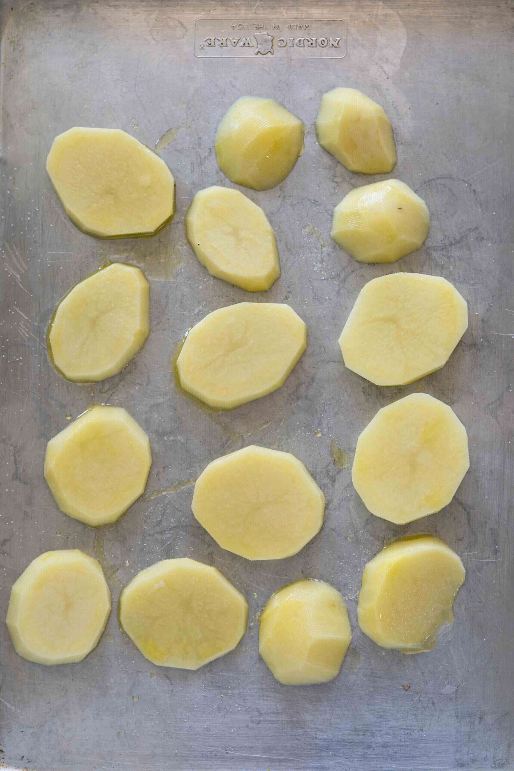 Potatoes before baking in a baking sheet