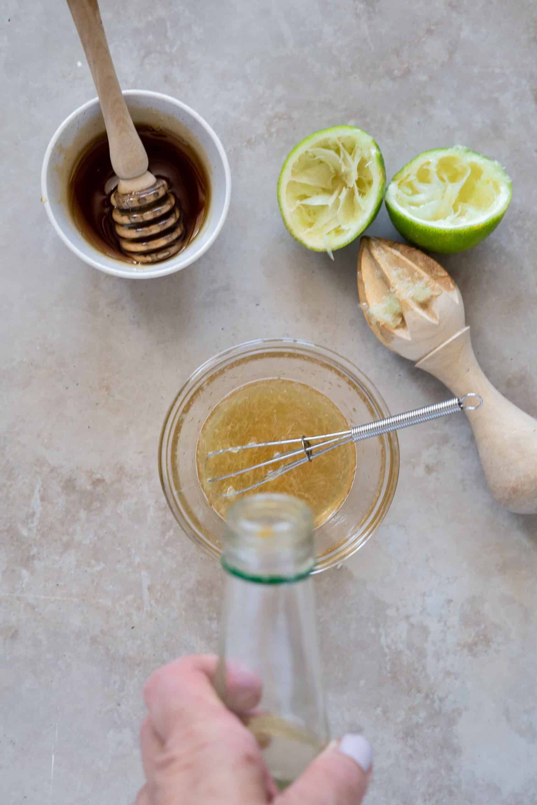 Mixing dressing: Pouring some orange blossom water over squeezed lime mixed with honey
