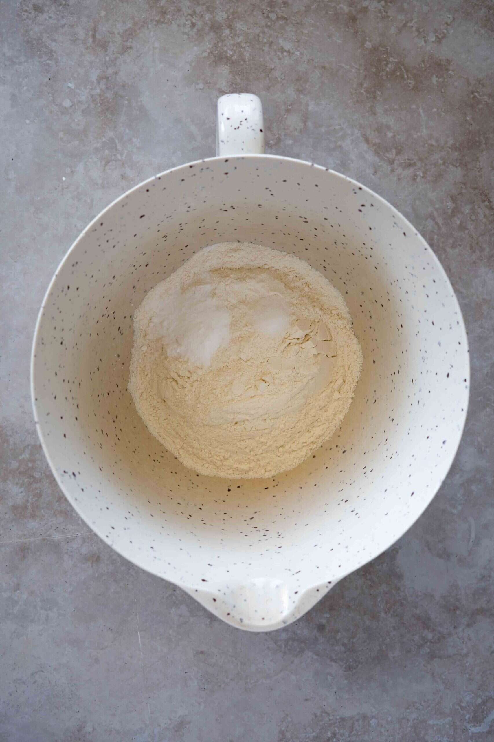 Mixing dry ingredients in a bowl (all-purpose flour, baking soda and salt)