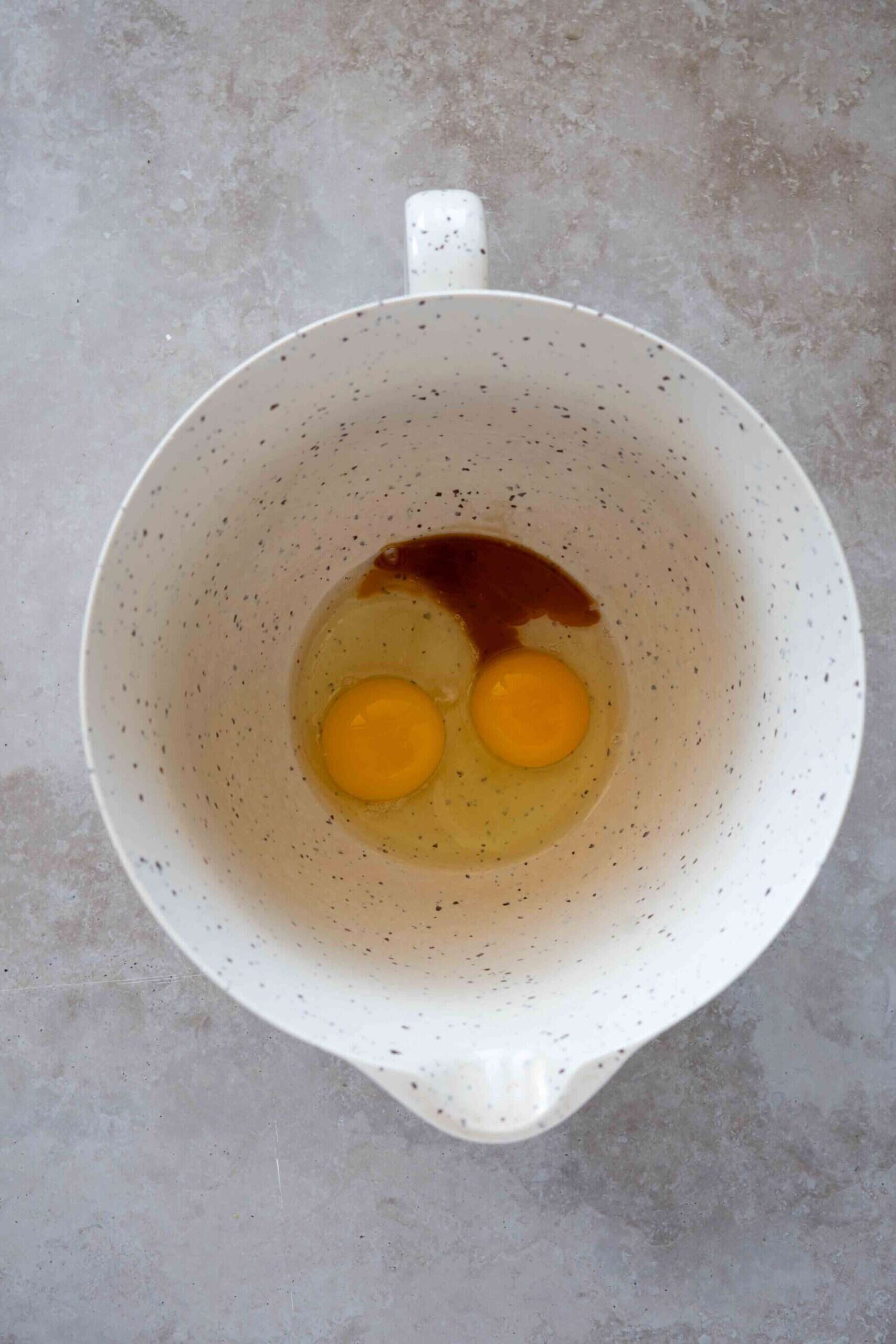 Eggs and vanilla in a mixer before mixing