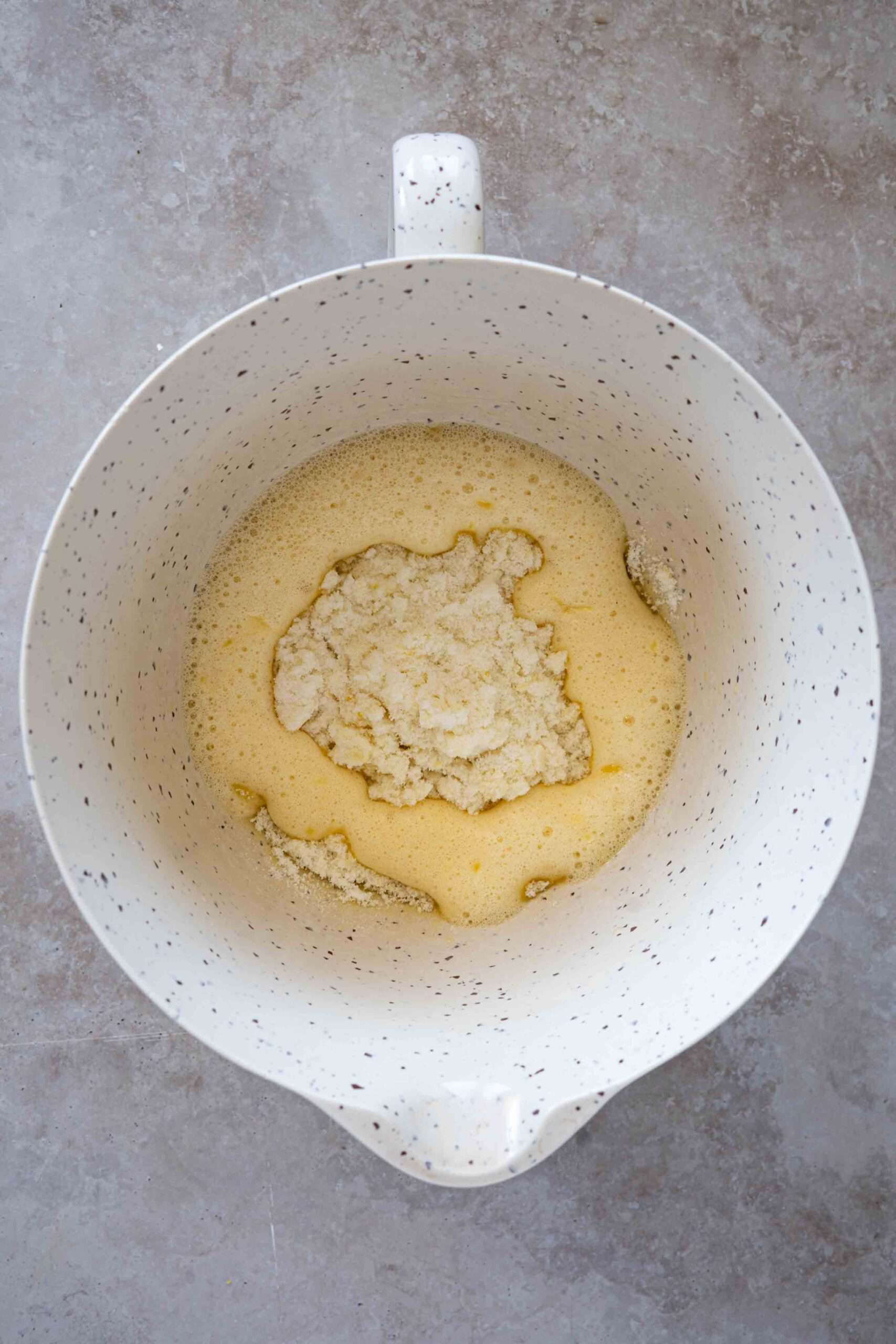 Sugar and lemon zest added over egg mixture