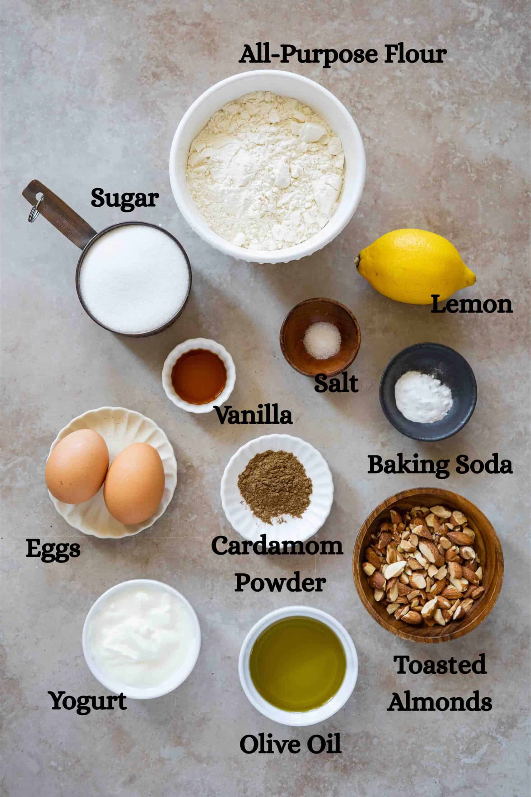 Cardamom cake ingredients: All-purpose flour, sugar, eggs, vanilla, salt, baking soda, zest of a lemon, cardamom powder, yogurt, olive oil and tasted almonds (optional)