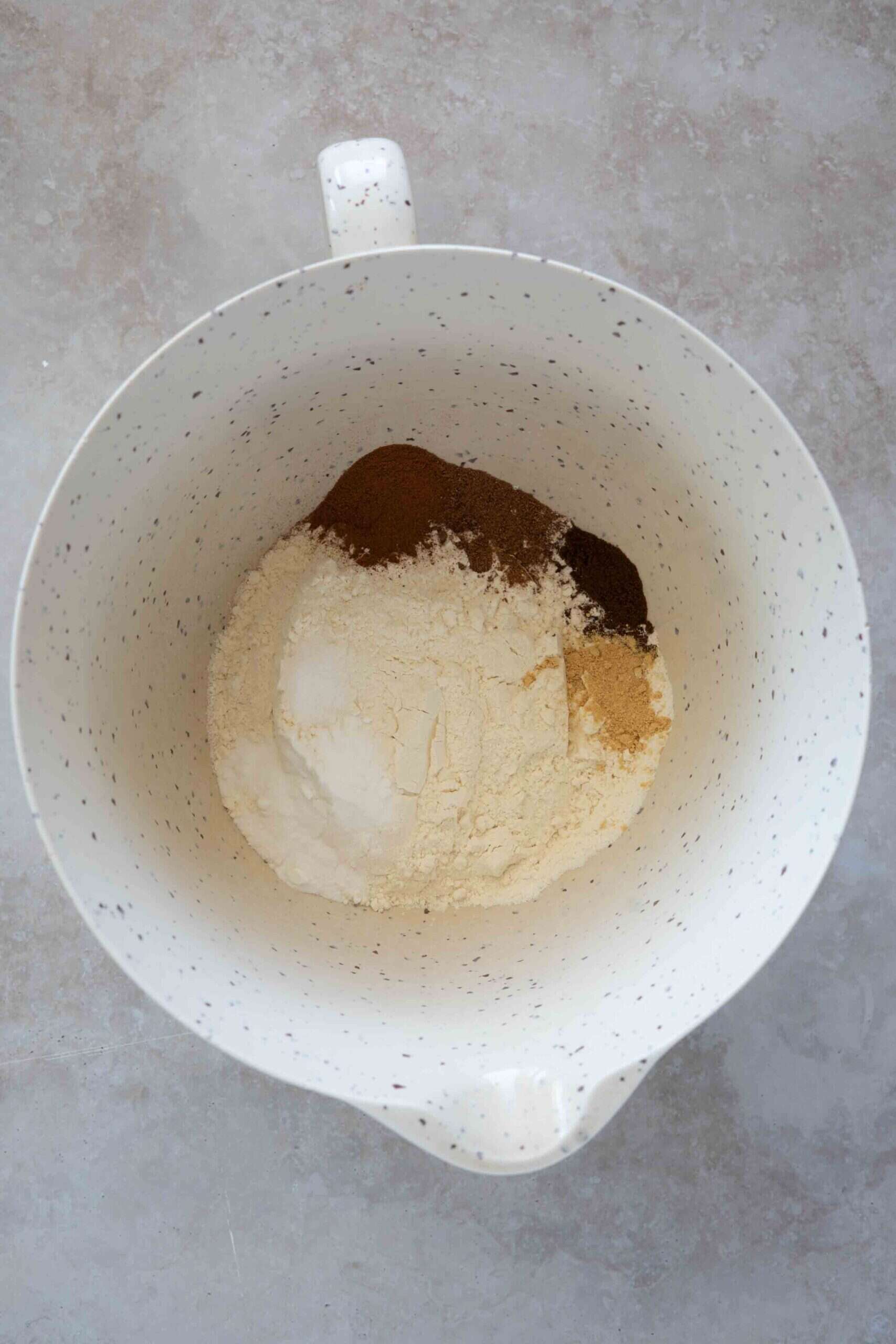 Dry ingredients in a bowl: flour, baking soda, salt, cinnamon, nutmeg, clove and ginger
