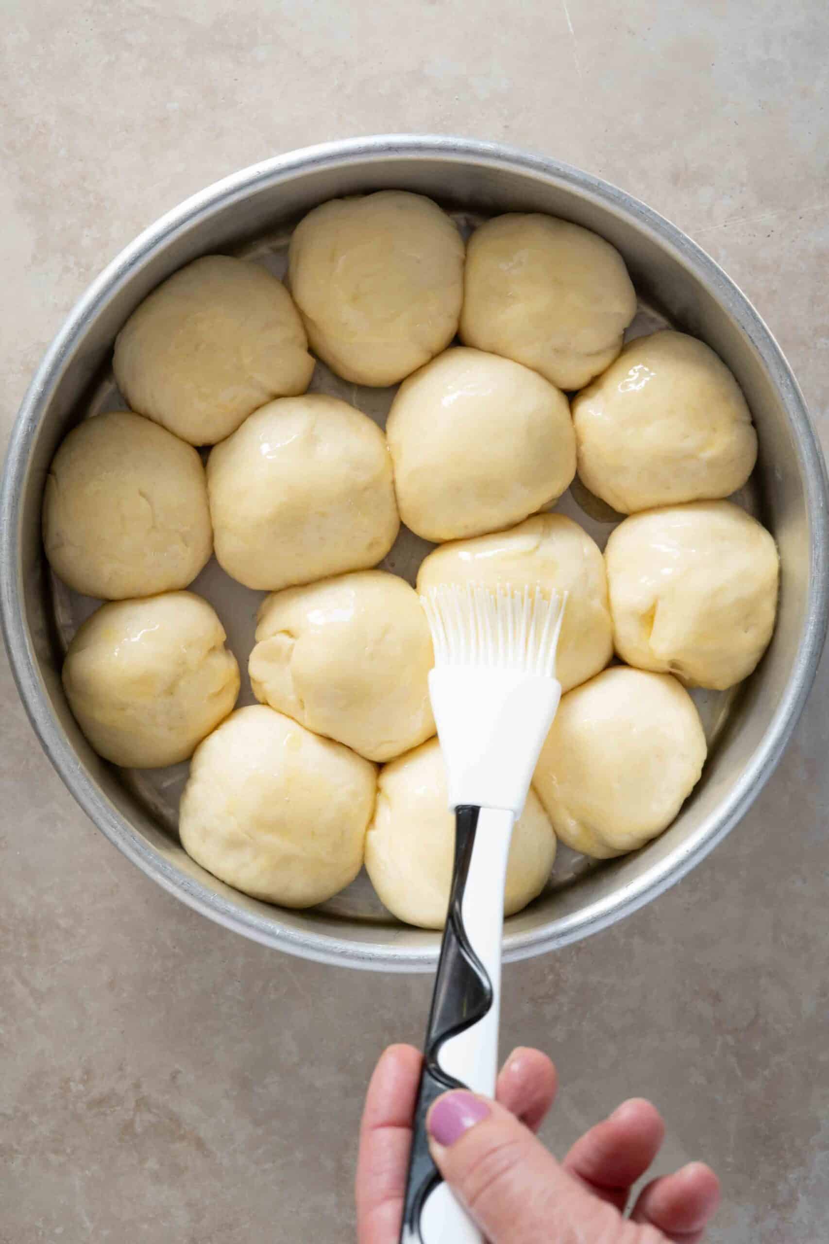 Dough cut into rounded pieces (about 1-2") and arranged in a round tray, then brushed with butter just before baking.