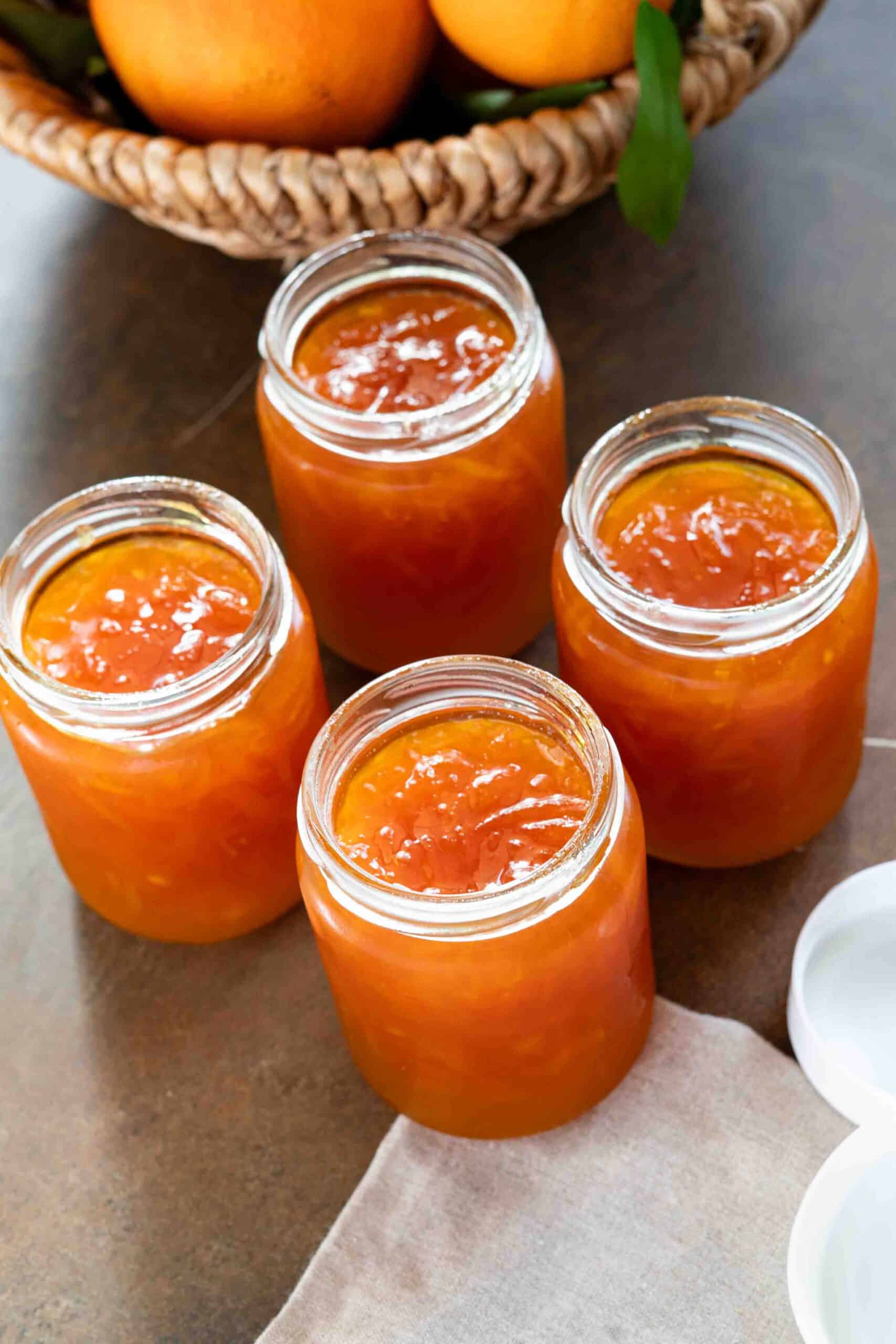 Four jars filled with orange jam