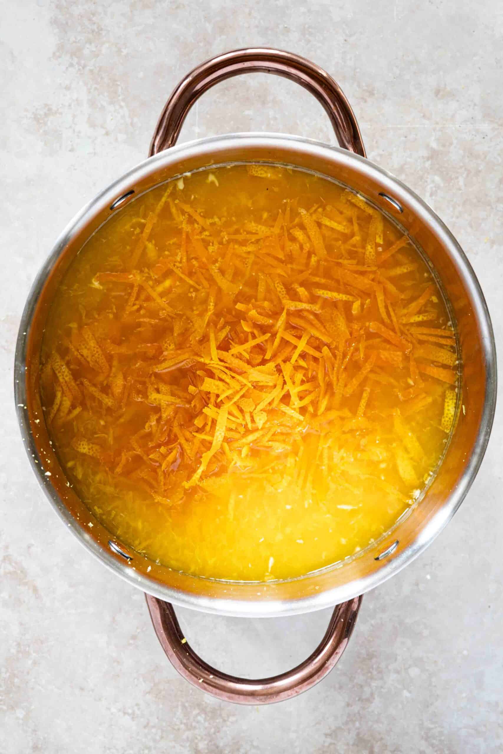 Thinly sliced oranges' skin, orange juice, lemon juice and lemon zest and sugar all in a pot.