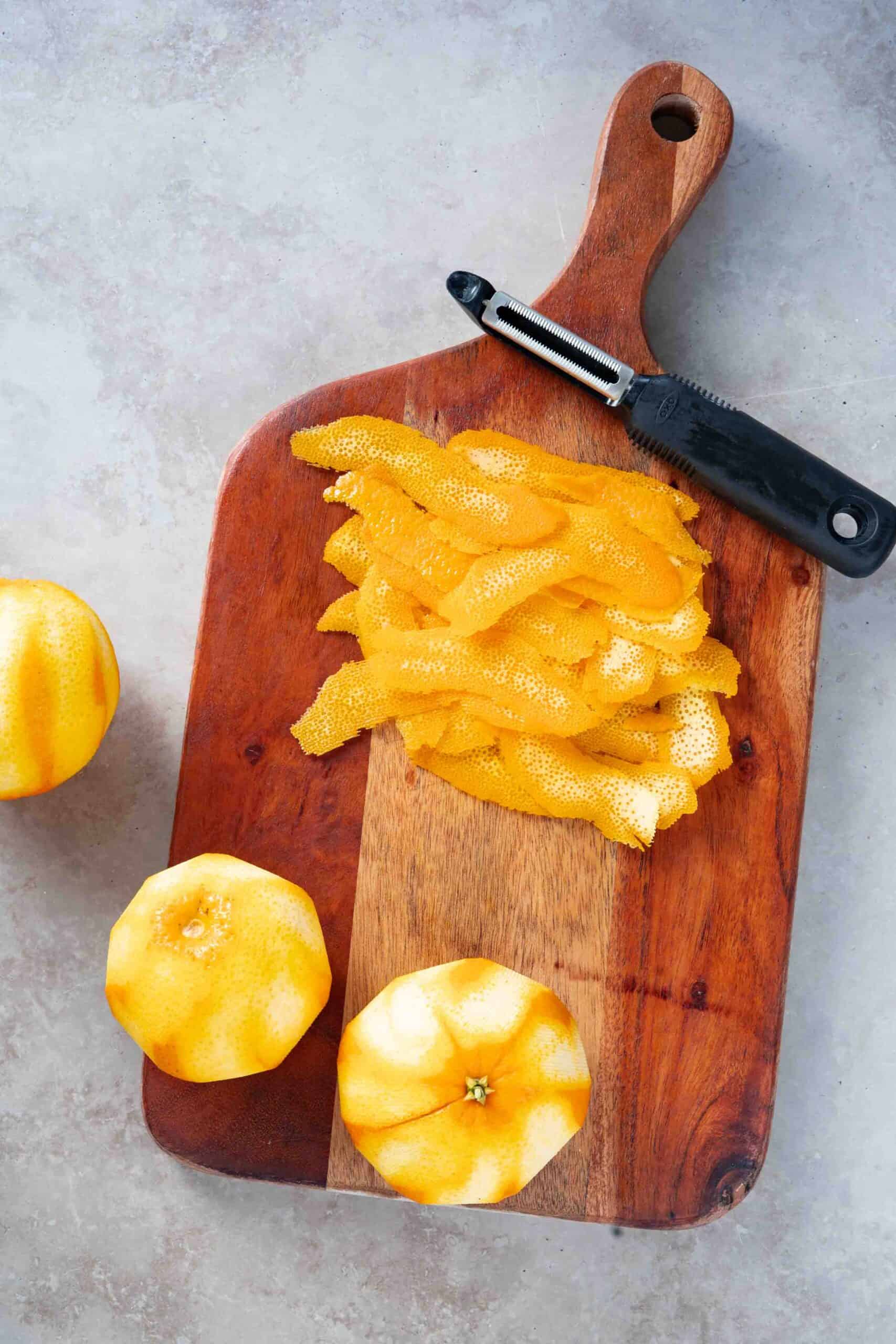 Peeling oranges with a peeler.