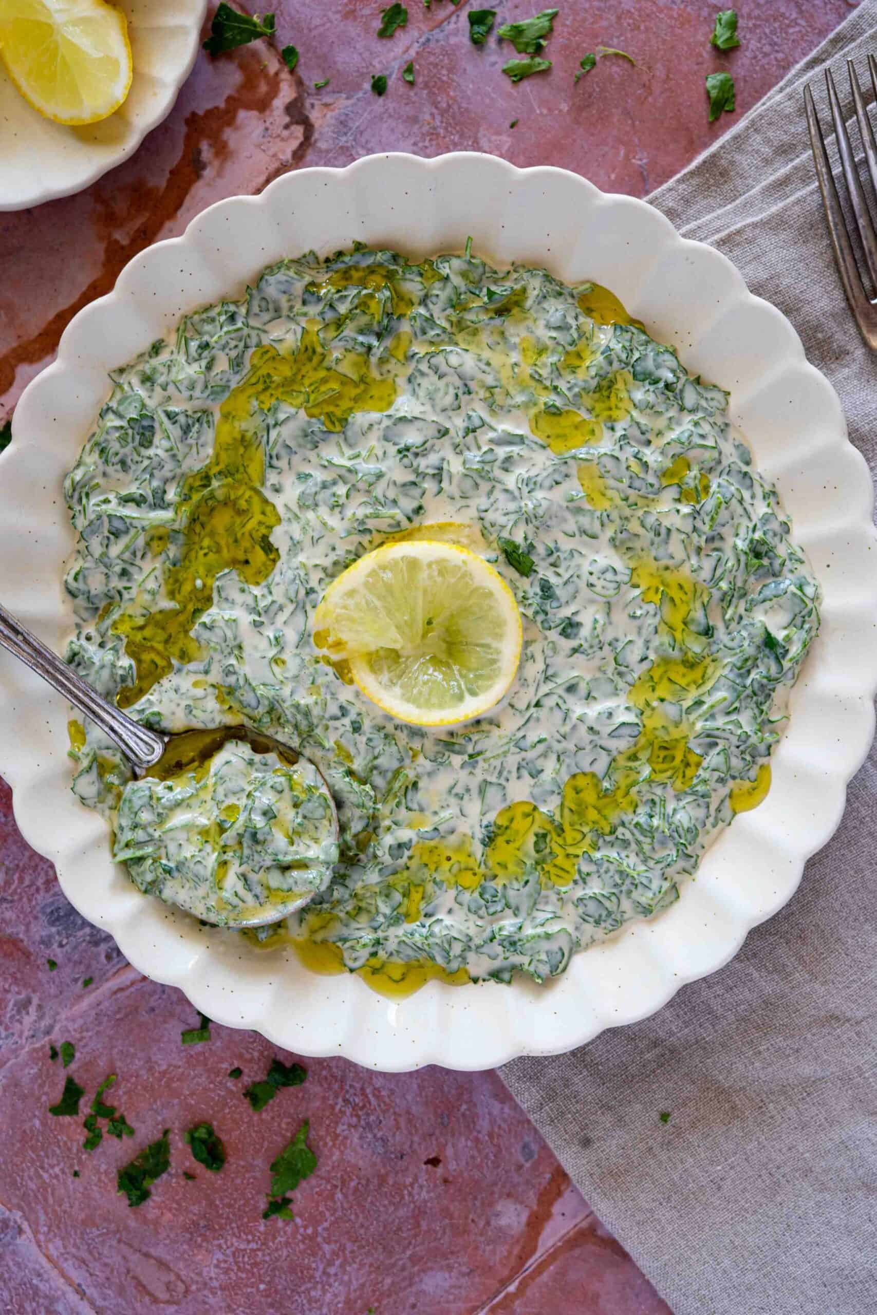 Parsley dip on a plate with a drizzle of olive oil - close up photo