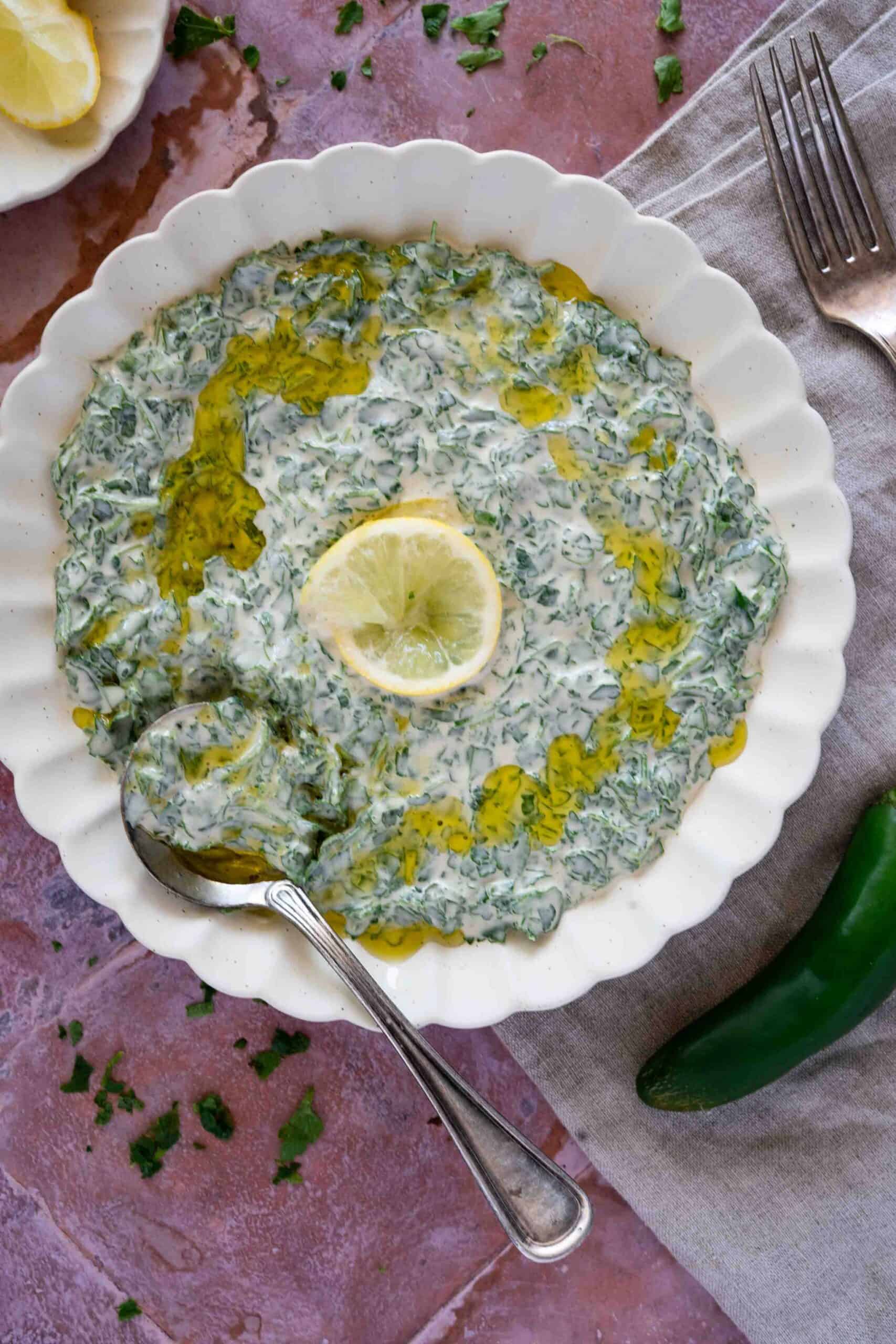 Parsley dip on a plate with a drizzle of olive oil