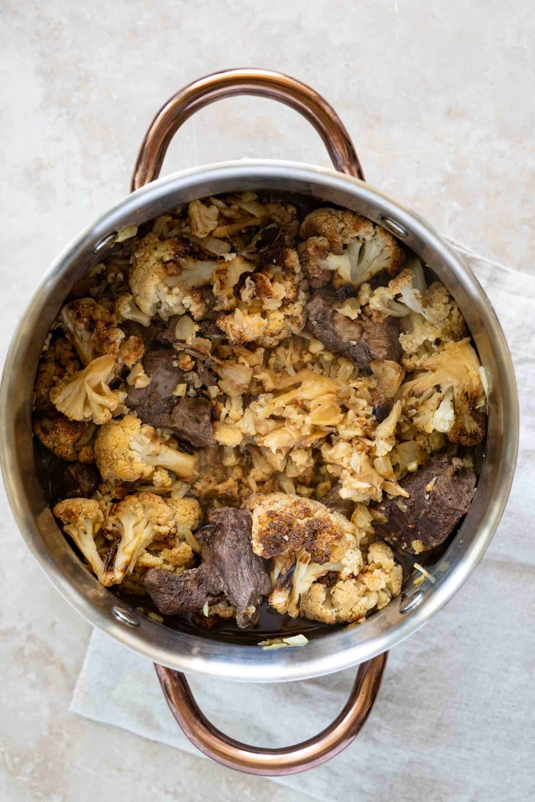 Cooked cauliflower with lamb stew in a pot
