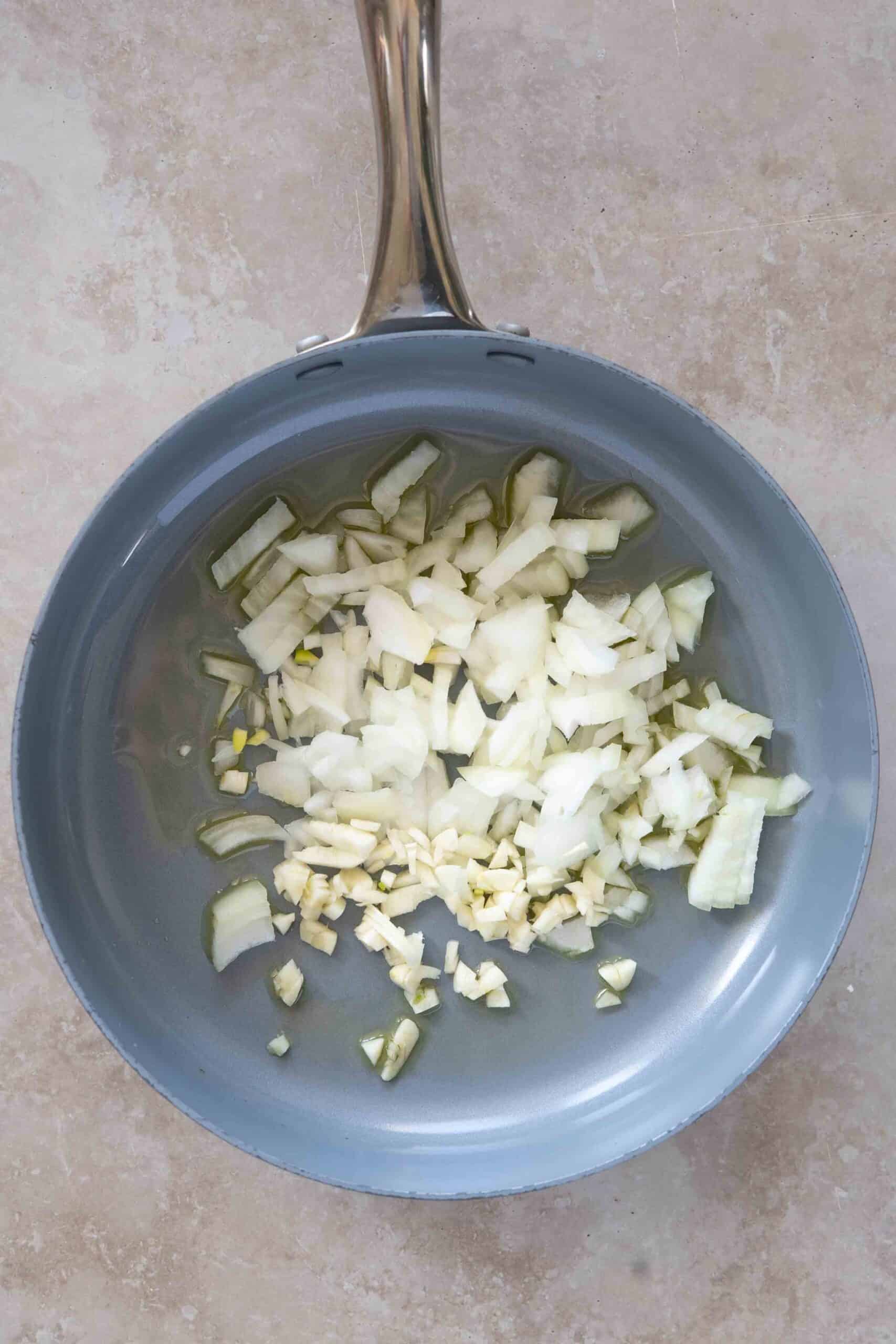 sautéing chopped onions in a skillet