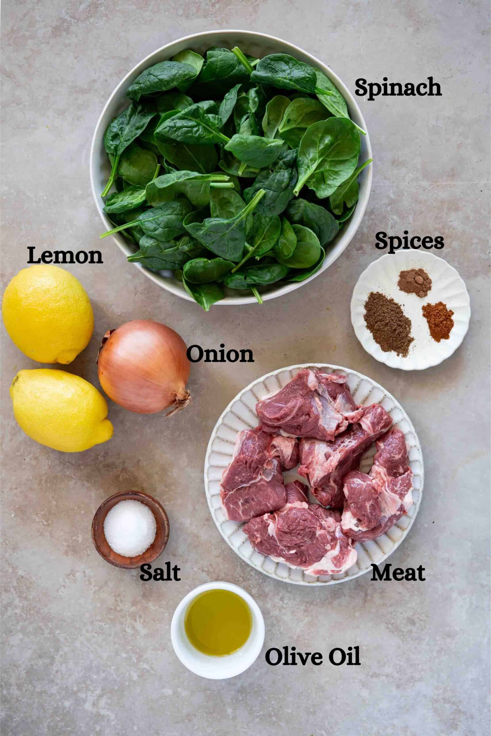 Spinach stew ingredients: spinach, lamb, onion, spices, lemon, salt and olive oil
