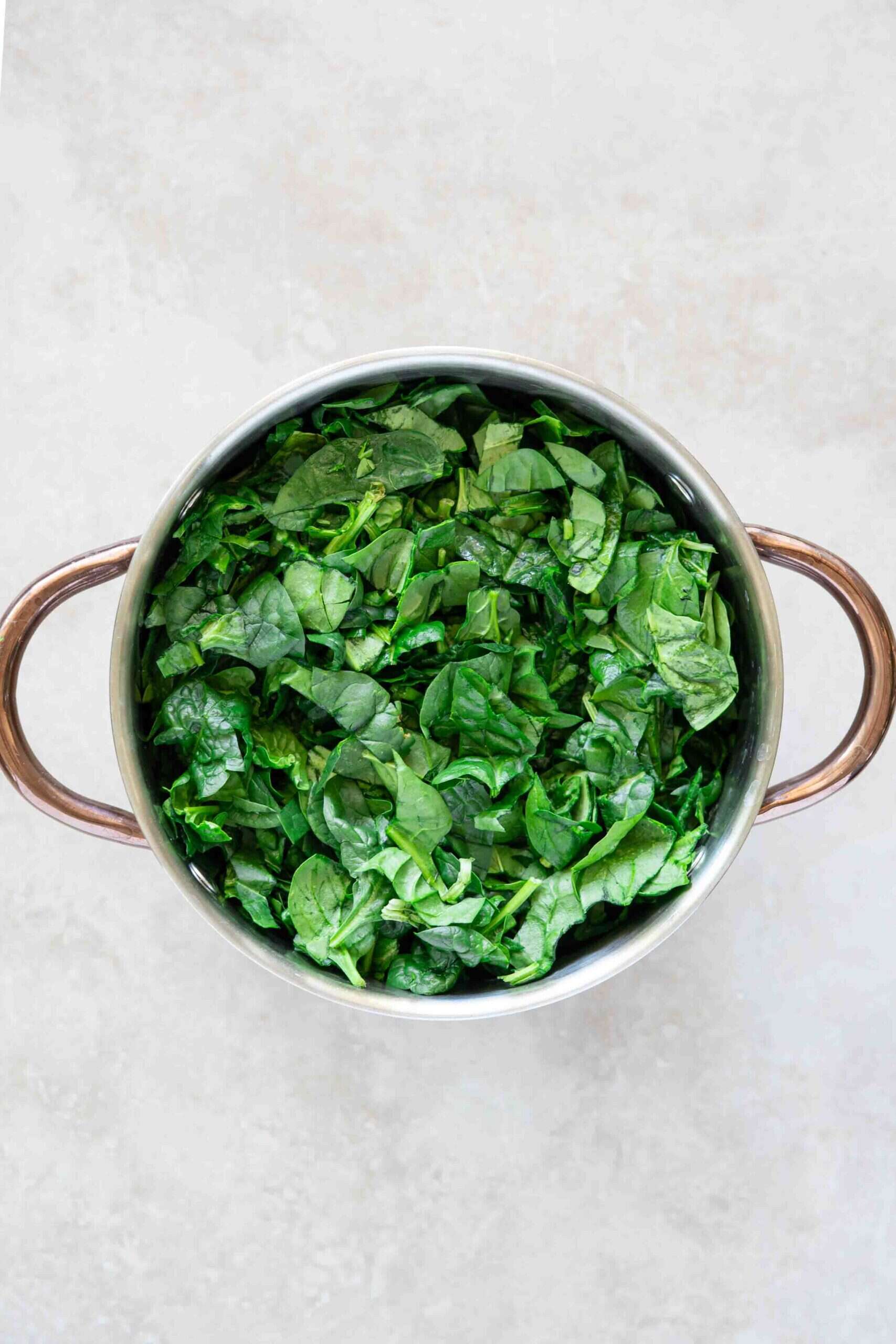 Chopped spinach inside cooking pot