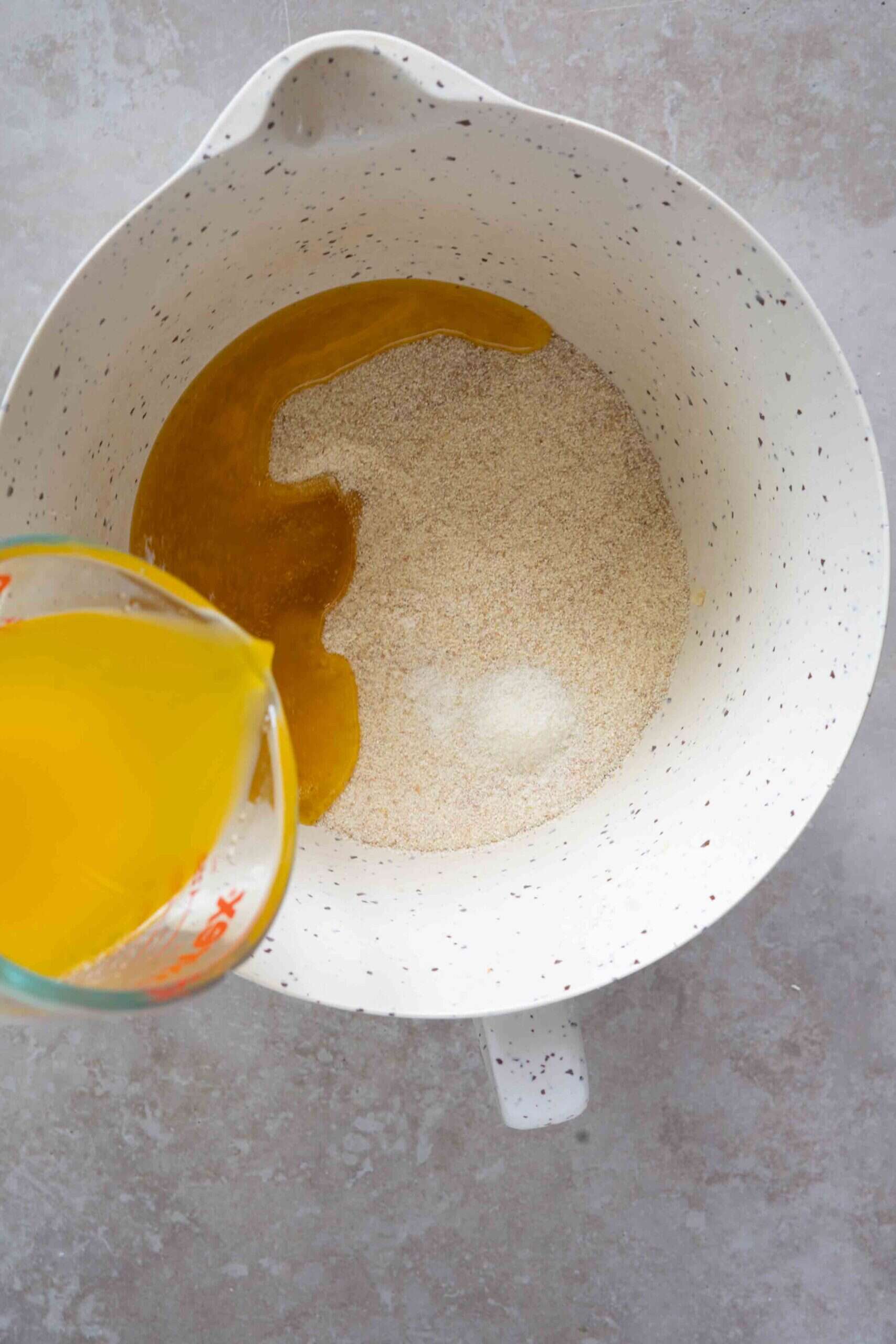 Pouring melted butter over farina mixture