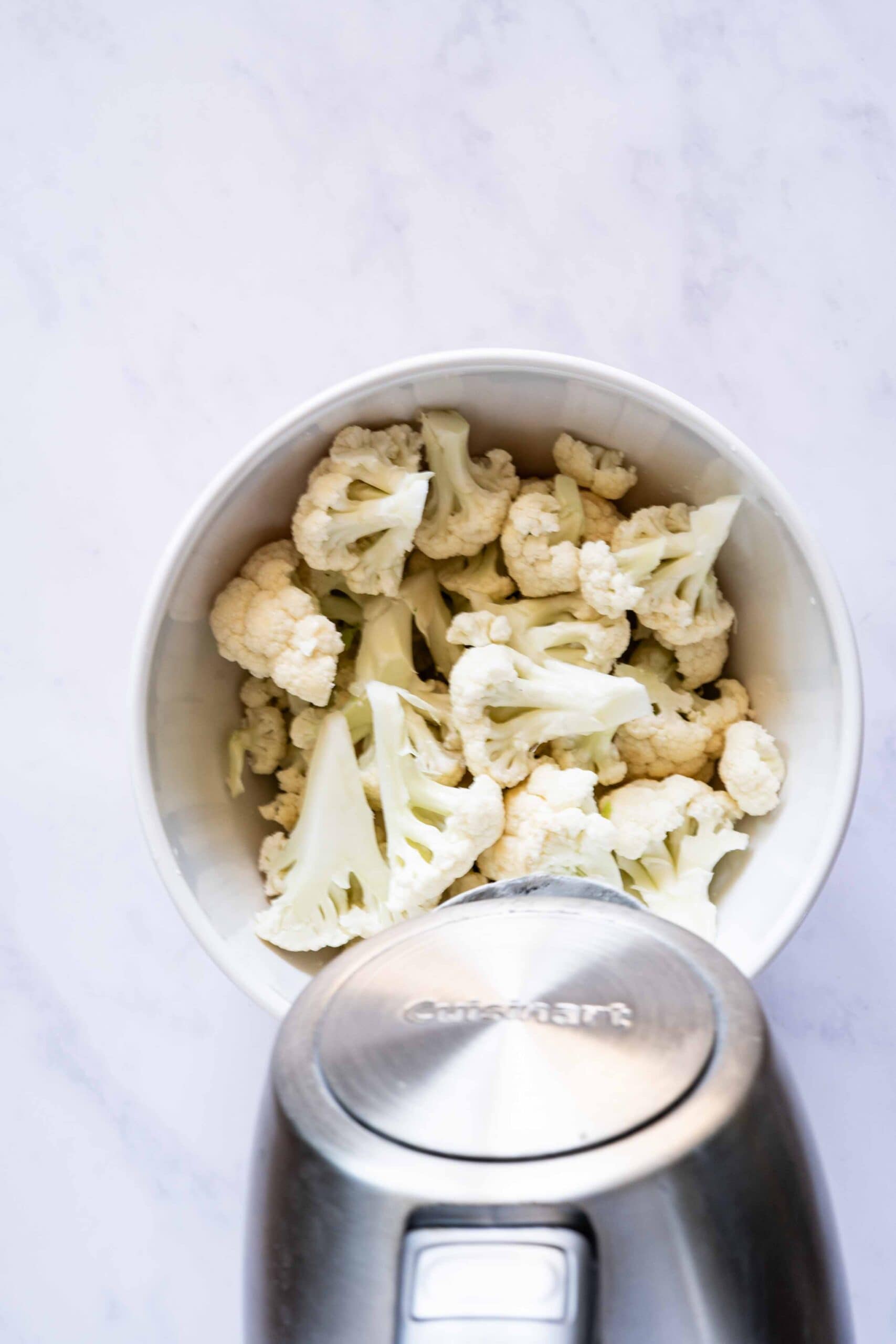 Pouring hot water over cauliflower florets