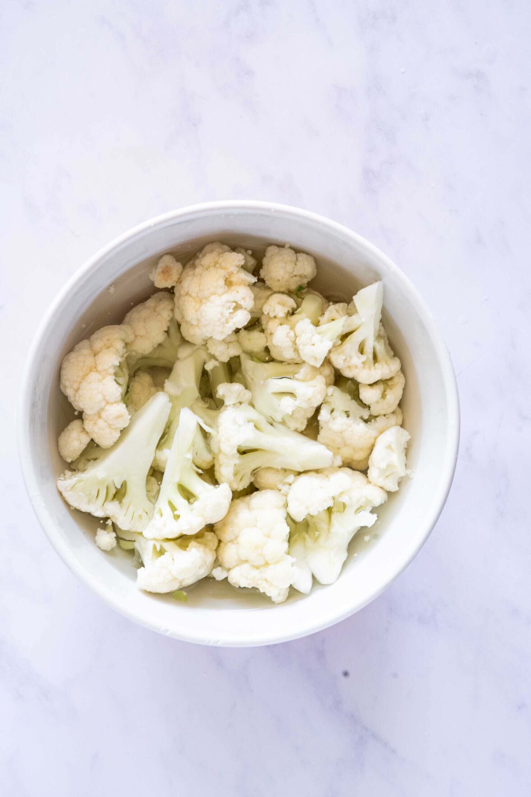 Covering cauliflower florets with hot water.
