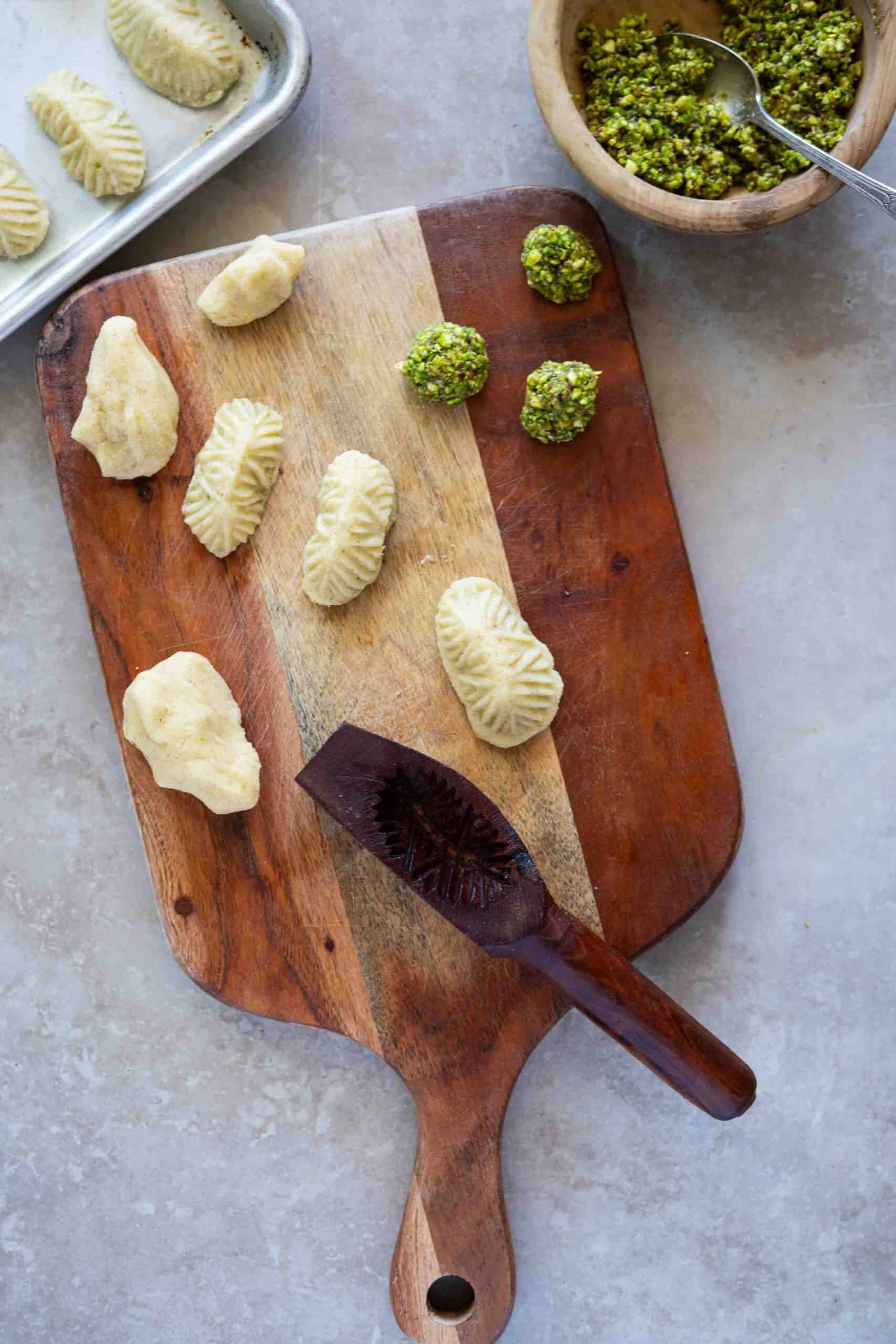 Cookies out of the mold fully stuffed and shaped placed on a surface