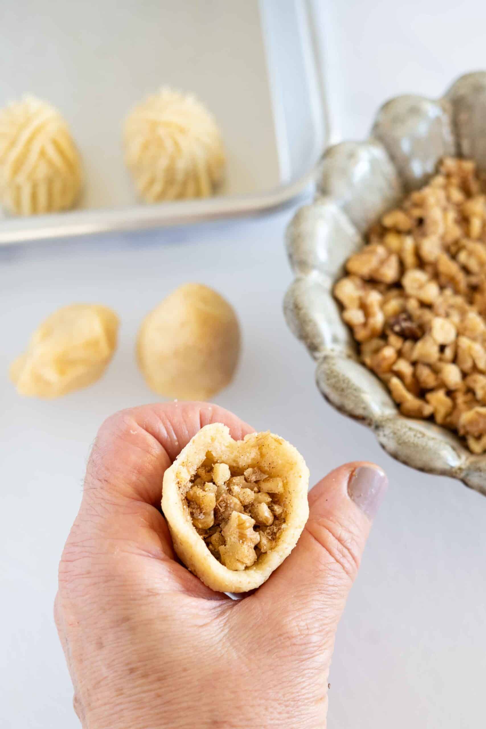 Fill the dough with 1 teaspoon of walnut filling.