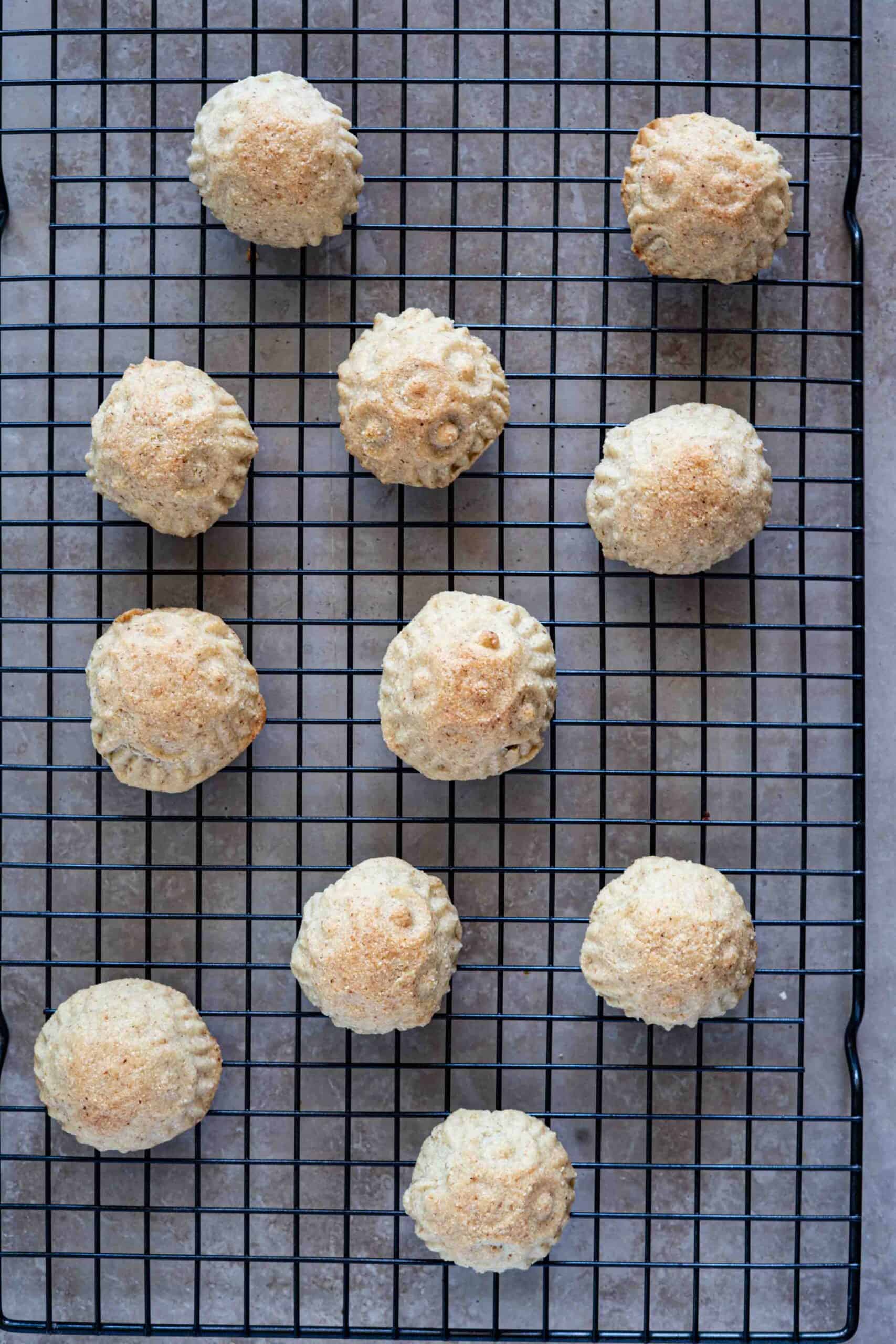 Maamoul cookies cooling on a wire rack after baking.