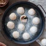 A close up photo for a rounded serving tray filled with maamoul, dusted with powdered sugar.
