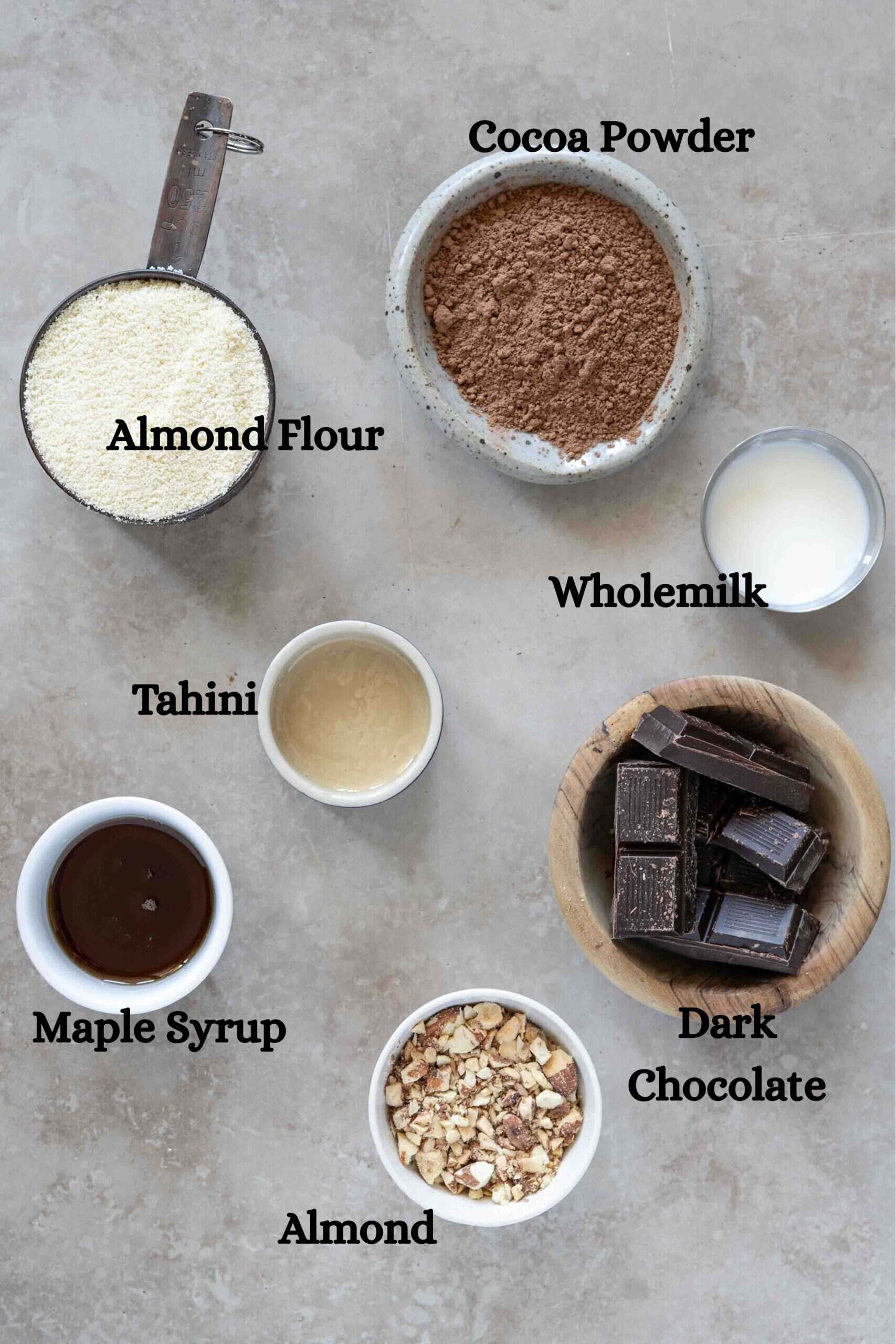 Tahini chocolate balls ingredients: Almond flour, cocoa powder, tahini, maple syrup, dark chocolate, wholemilk, toasted chopped almonds