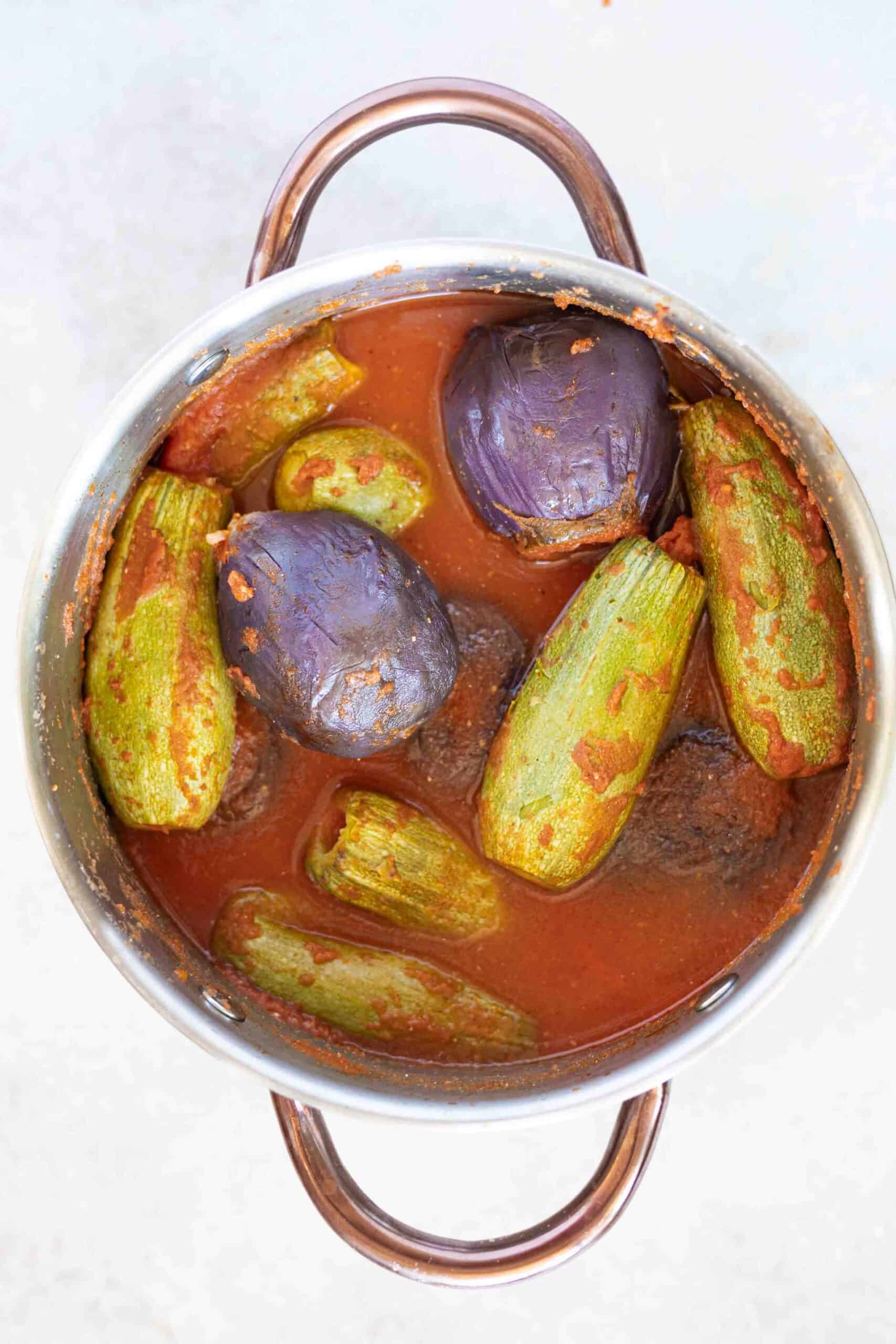 Mahshi (stuffed eggplants and zucchini) fully cooked in tomato sauce a pot