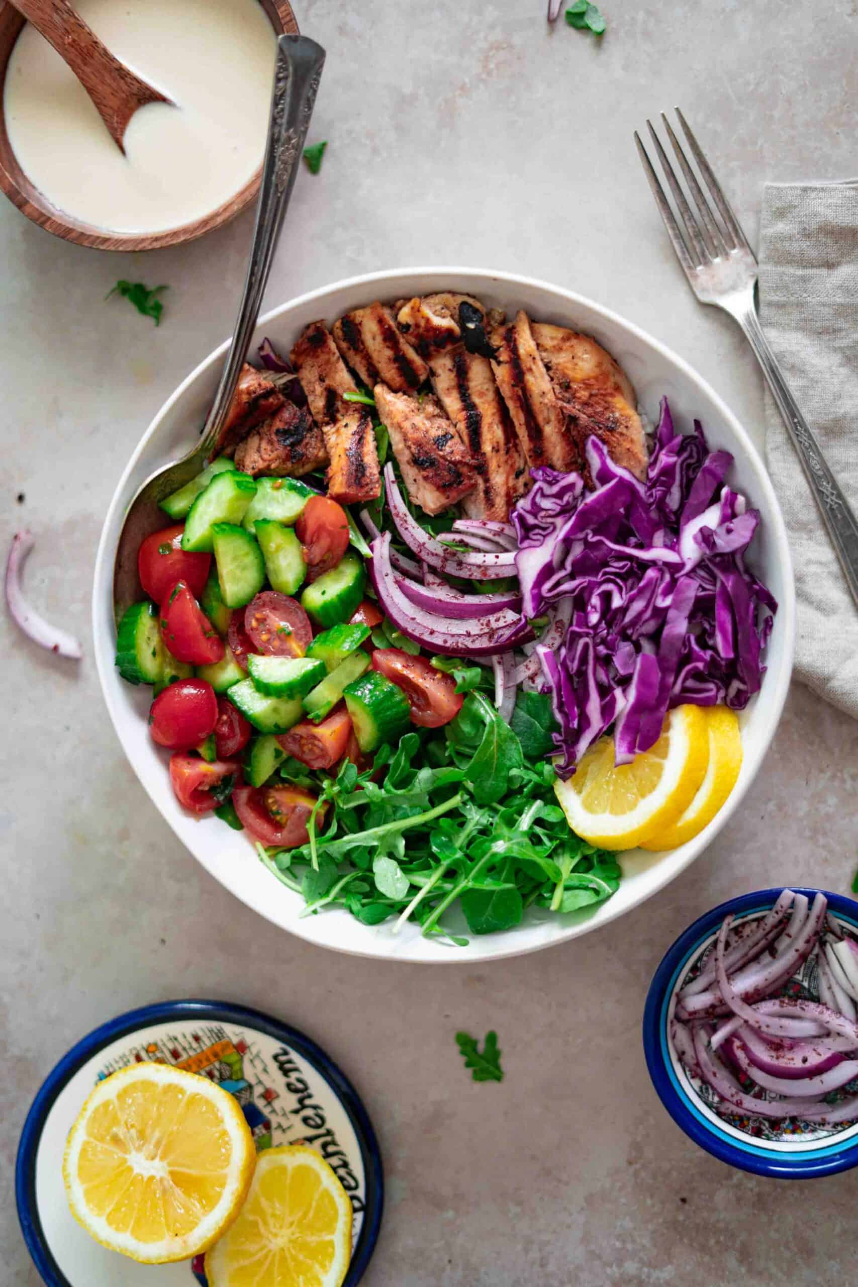 Assembling shawarma salad ingredients in a bowl