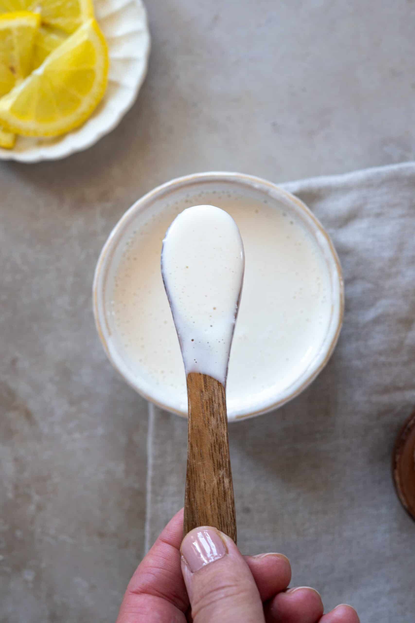 Holding a spoon with the sauce