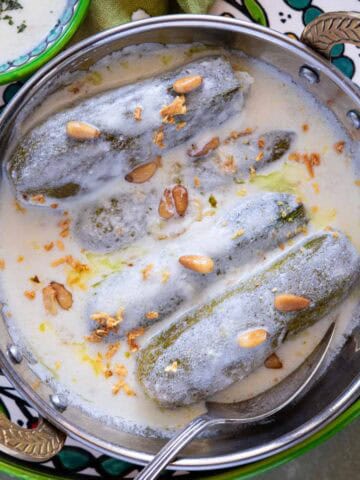 Traditional Palestinian Malfouf Dolma served with yogurt and pine nuts.