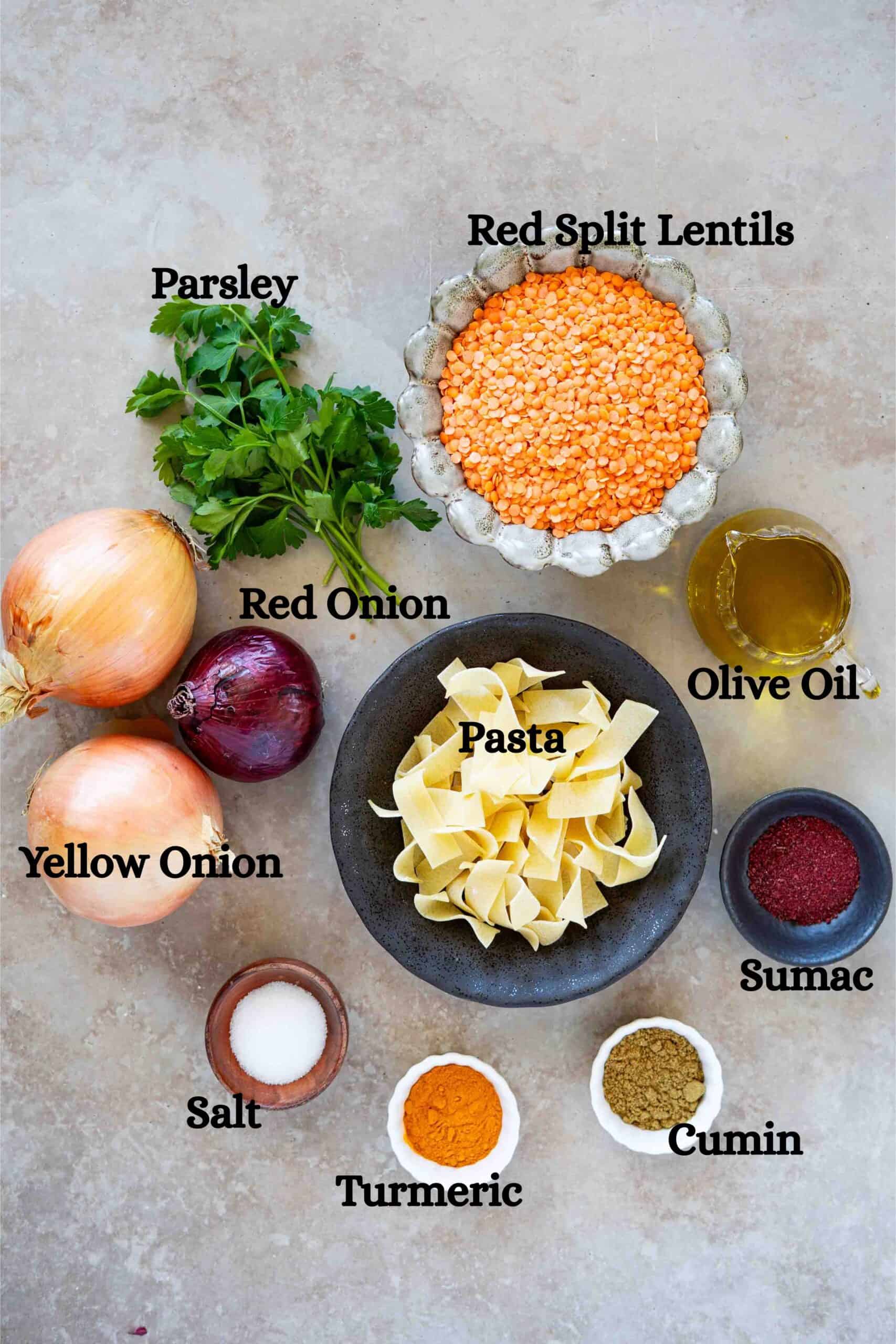 Rishtayeh ingredients: Red split lentils, Pappardelle pasta, cumin powder turmeric, salt, yellow onion, olive oil red onion, sumac powder, and parsley.