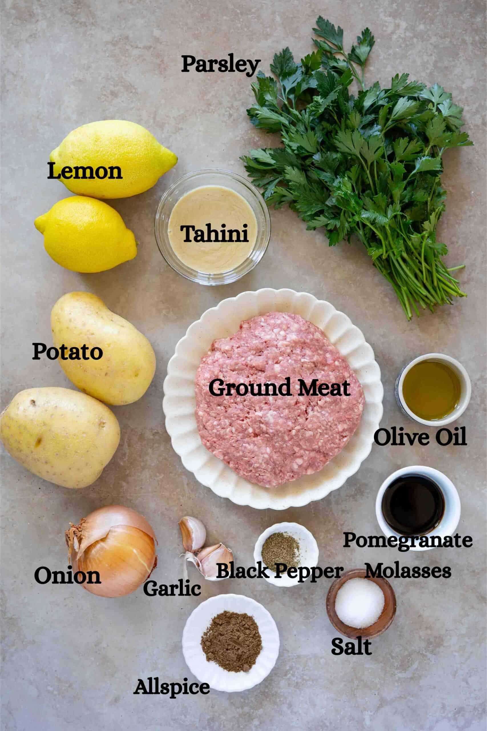Kafta bil tahini ingredients: ground meat, parsley, onion, garlic, allspice, black pepper, salt, pomegranate molasses, tahini, lemon and potato.