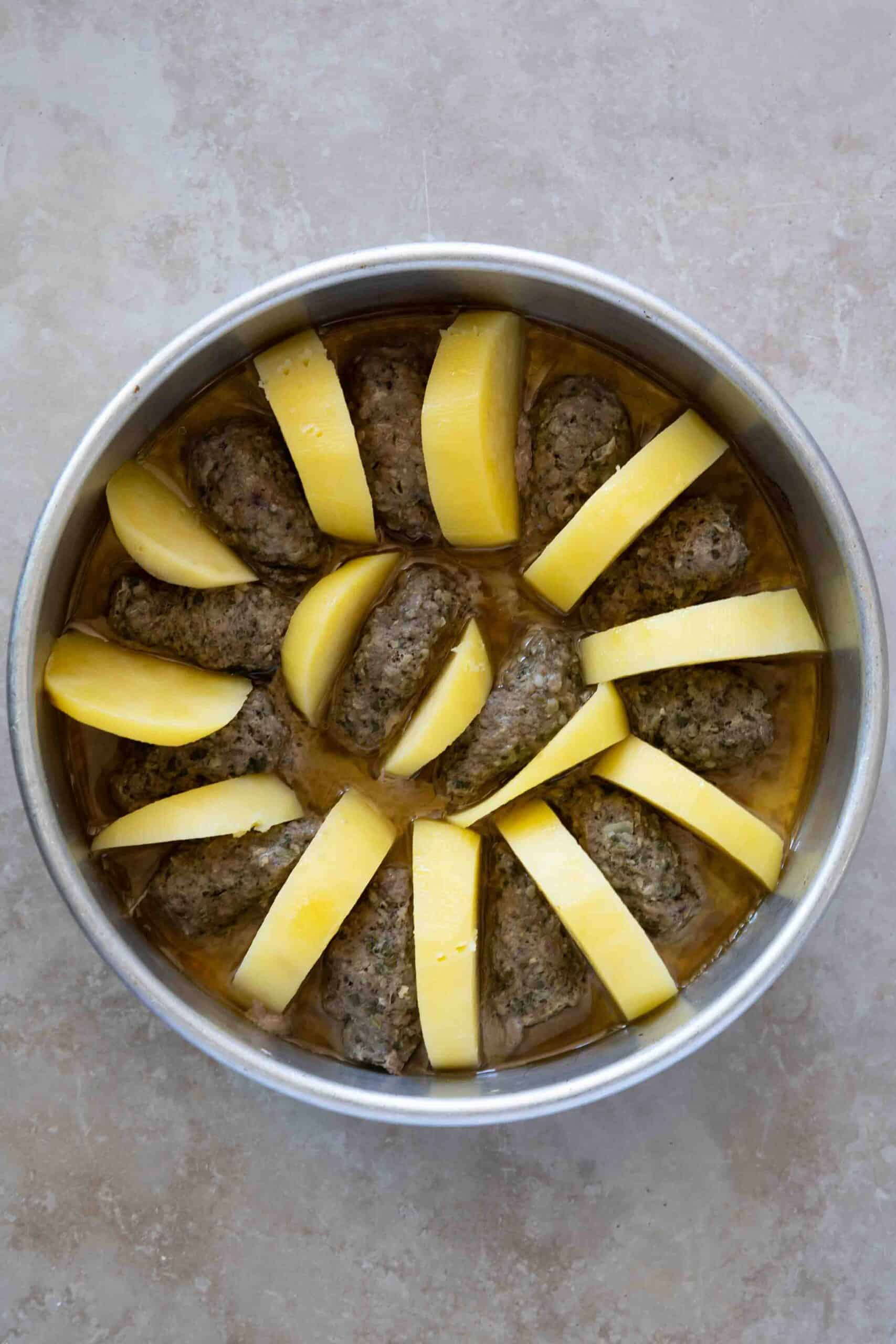 Kafta and potatoes after baking in a baking pot.