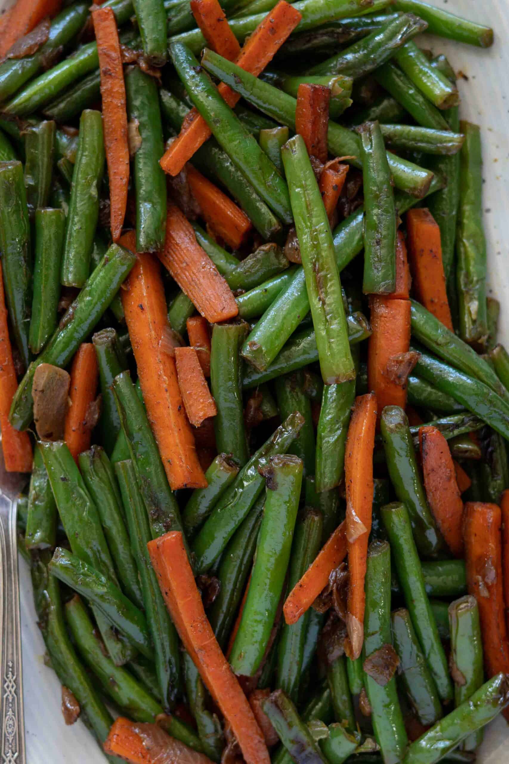 A close up photo for carrot and beans served in a plate